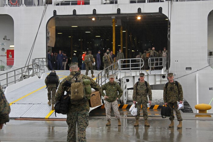 Marines and sailors with Marine Wing Support Squadron 171 and Combat Logistics Company 36 make their way onto a high-speed vessel bound for Korea at the Marine Corps Air Station Iwakuni harbor March 23. The Marines and sailors travelled to Korea to support Exercise Foal Eagle 2010.
