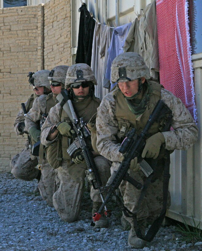 Marines of Bravo Company, 1st Battalion, 8th Marine Regiment, 2nd Marine Division, take cover while dealing wait a possible Improvised Explosive Device during their Counter-IED training at the Military Operations on Urban Terrain Training Center, aboard Marine Corps base Camp Lejeune, N.C., March 24, 2010. The Marines spent a week learning how to deal with an IED environment.