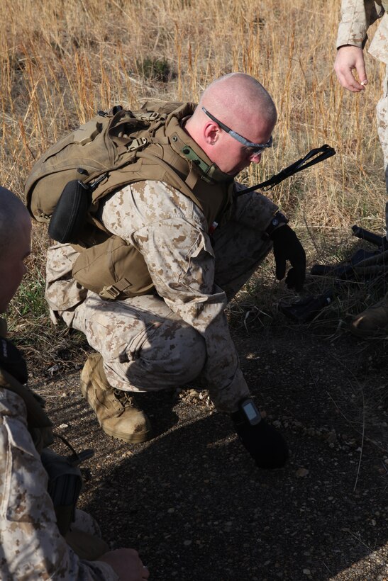 A Marine infantry officer with India Company, Battalion Landing Team 3/8, improvises a terrain model of his squad’s next training exercise out of rocks and grass aboard Ft. Pickett, Va., March 24, 2010. BLT 3/8 is one of the three units that joined the 26th Marine Expeditionary Unit, which will spend the next six months training for its upcoming deployment. (Official United States Marine Corps Photo By Cpl. Jesse J. Johnson) ::r::::n::