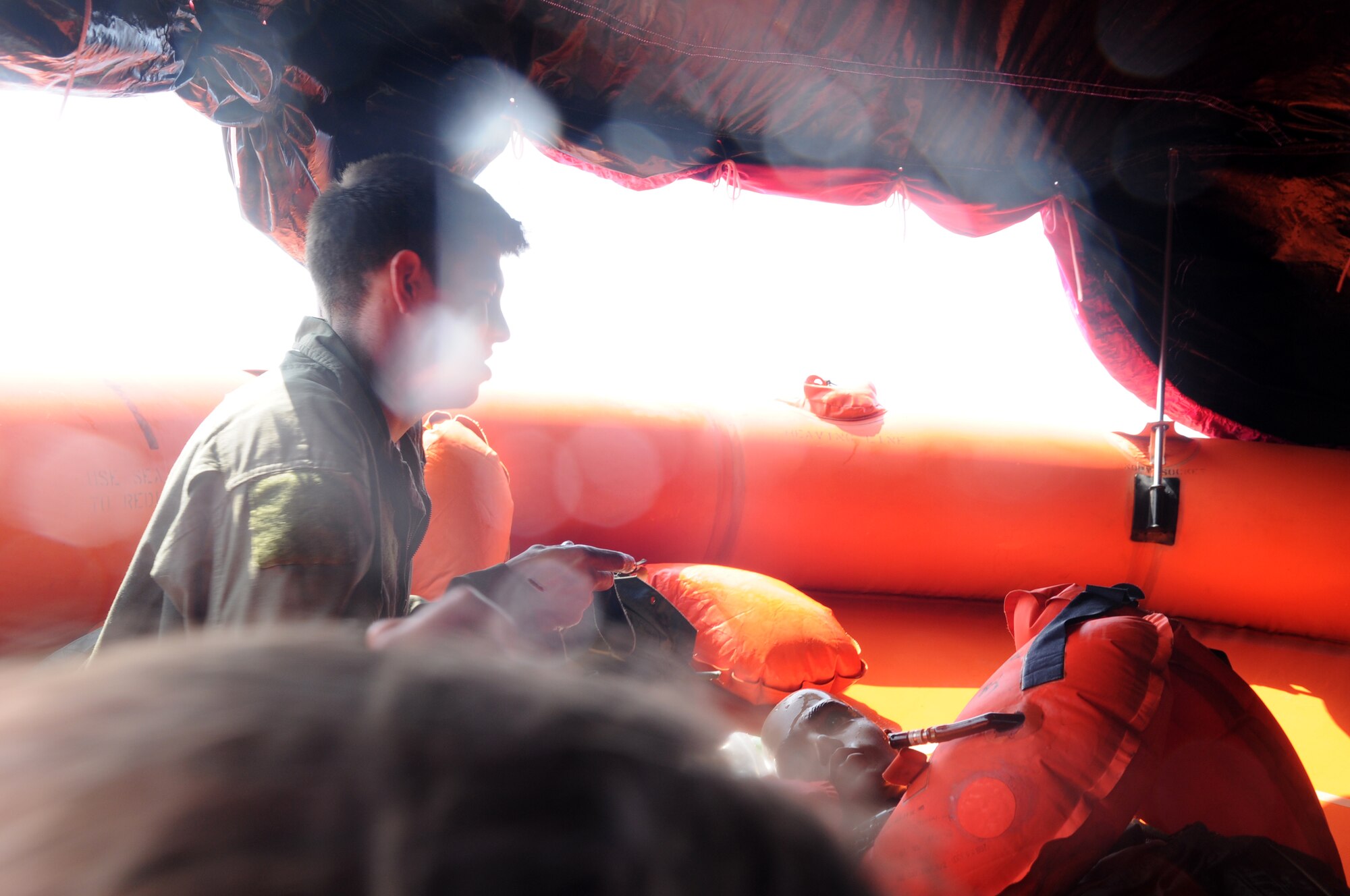 Senior Airman James Sharp, a member of the 961st Airborne Air Control Squadron, performs self aid and buddy care on a “victim” during a simulated aircraft emergency water landing at Kadena Air Base, Japan, March 24. Members of the 961st AACS spent the afternoon training proper emergency landing and water survival procedures. The training was part of Beverly High 10-02, a Local Operational Readiness Exercise designed to evaluate the readiness of Kadena Airmen. (U.S. Air Force photo/Senior Airman Amanda N. Grabiec)