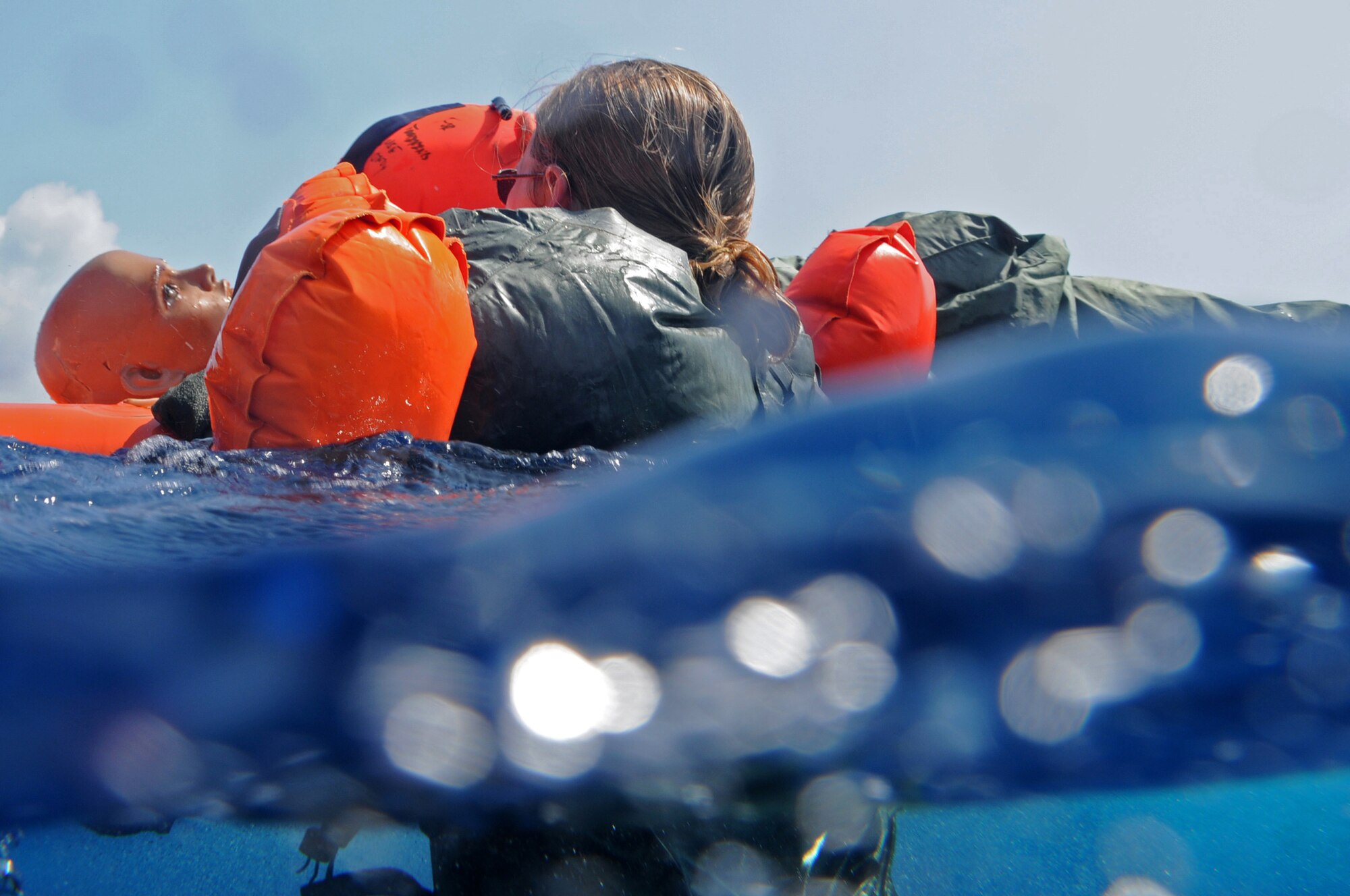 First Lieutenant Leslie Woll, an air battle manager with the 961st Airborne Air Control Squadron, tends to a “victim” during a simulated aircraft emergency water landing at Kadena Air Base, Japan, March 24. Members of the 961st AACS spent the afternoon training proper emergency landing and water survival procedures. The training was part of Beverly High 10-02, a Local Operational Readiness Exercise designed to evaluate the readiness of Kadena Airmen. (U.S. Air Force photo/Senior Airman Amanda N. Grabiec)