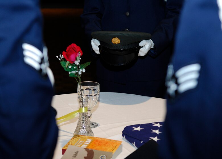 VANDENBERG AIR FORCE BASE, Calif. -- Honoring current, past and present prisoners of war and those missing in action, Airman Leadership School students perform a POW/MIA ceremony during the ALS graduation ceremony here Tuesday, March 23, 2010. The table and each part of the ceremony represents a vital element and recognizes servicemembers who are or were missing. (U.S. Air Force photo/Senior Airman Heather R. Shaw)
