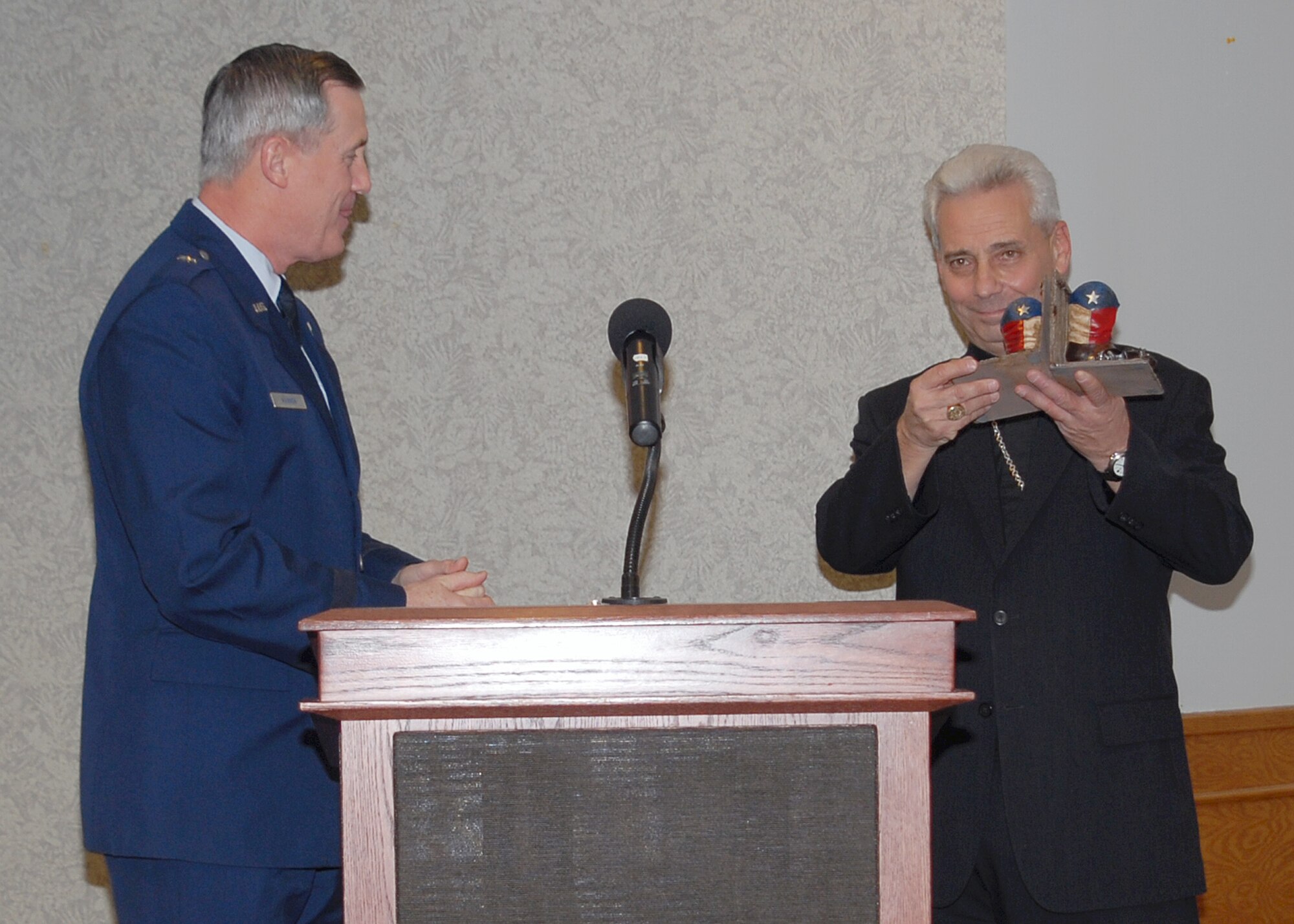 Brig. Gen. O.G. Mannon, 82nd Training Wing commander, presents Bishop Joseph Estabrook, with Texas book ends as a token of appreciation on behalf of the Religious services and Sheppard, after speaking at the National Prayer breakfast March 18. (U.S. Air Force Photo/ Lou Anne Sledge)