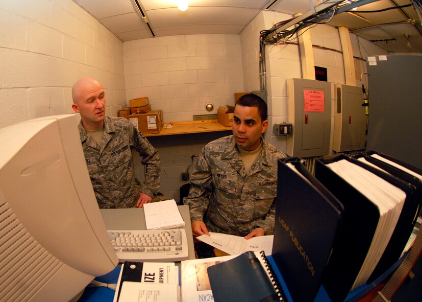 Staff Sgts. Douglas McNeilly and Jose Reyes, 22nd Communications Squadron technicians, monitor McConnell’s Tactical Air Navigation system’s power levels March 10, 2010, at McConnell Air Force Base, Kan. The 22nd CS technicians use the computer for remote access to monitor McConnell’s TACAN system and to trouble shoot faulty equipment. The $250,000 system is a navigational aid to help guide aircrew to the base. (U.S. Air Force photo/Airman 1st Class Andrea Salazar)