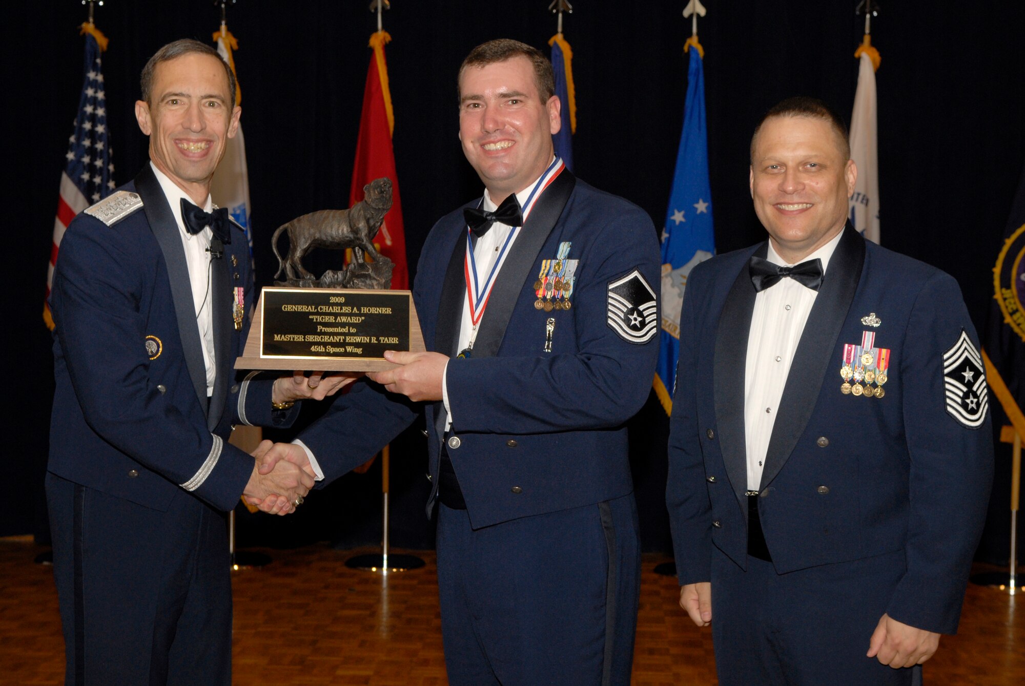 VANDENBERG AIR FORCE BASE, Calif. -- Master Sgt. Erwin Tarr, with the 5th Space Launch Squadron at Patrick Air Force Base, Fla., receives the Enlisted Tiger Award from Lt. Gen. Larry James, the 14th Air Force commander, and Chief Master Sgt. James MacKinley, the 14th AF command chief master sergeant, during the 14th Air Force Annual Awards Ceremony at the Pacific Coast Club here Thursday, March 18, 2010.   (U.S. Air Force photo/Senior Airman Andrew Satran) 

 

 

 

 

 

 

 

 

 

 

 
 