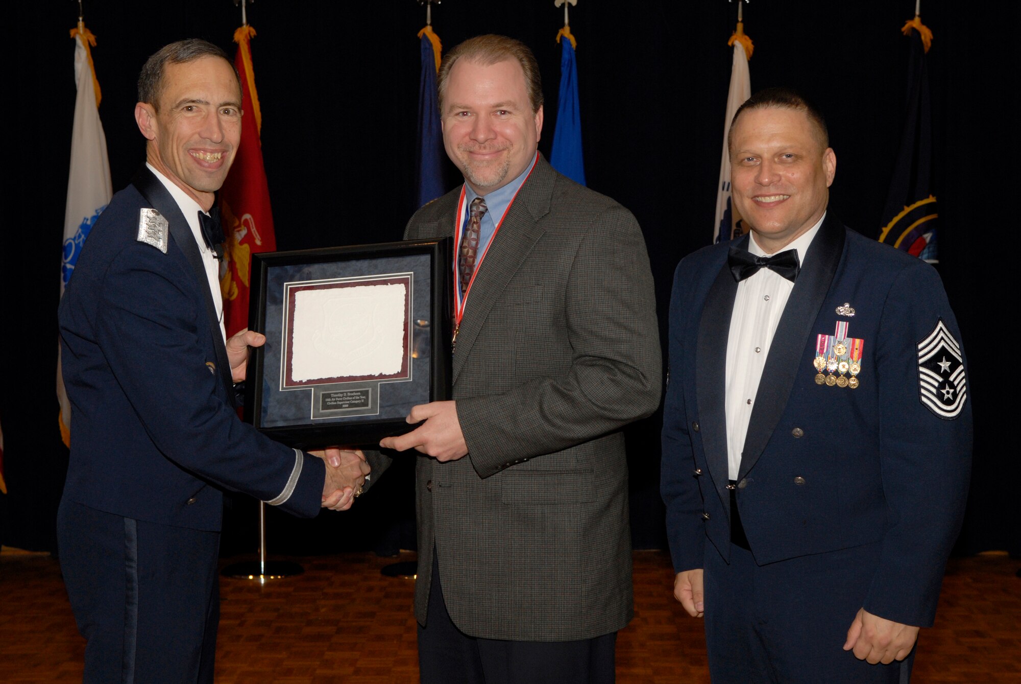 VANDENBERG AIR FORCE BASE, Calif. -- Mr. Timothy Brecheen, from the 50th Space Wing at Schriever Air Force Base, Colo., receives the 14th Air Force Civilian Supervisor of the Year Category 2 Annual Award from Lt. Gen. Larry James, the 14th Air Force commander, and Chief Master Sgt. James MacKinley, the 14th AF command chief master sergeant, during the 14th Air Force Annual Awards Ceremony at the Pacific Coast Club here Thursday, March 18, 2010.   (U.S. Air Force photo/Senior Airman Andrew Satran) 

 

 

 

 

 

 

 

 

 
 
