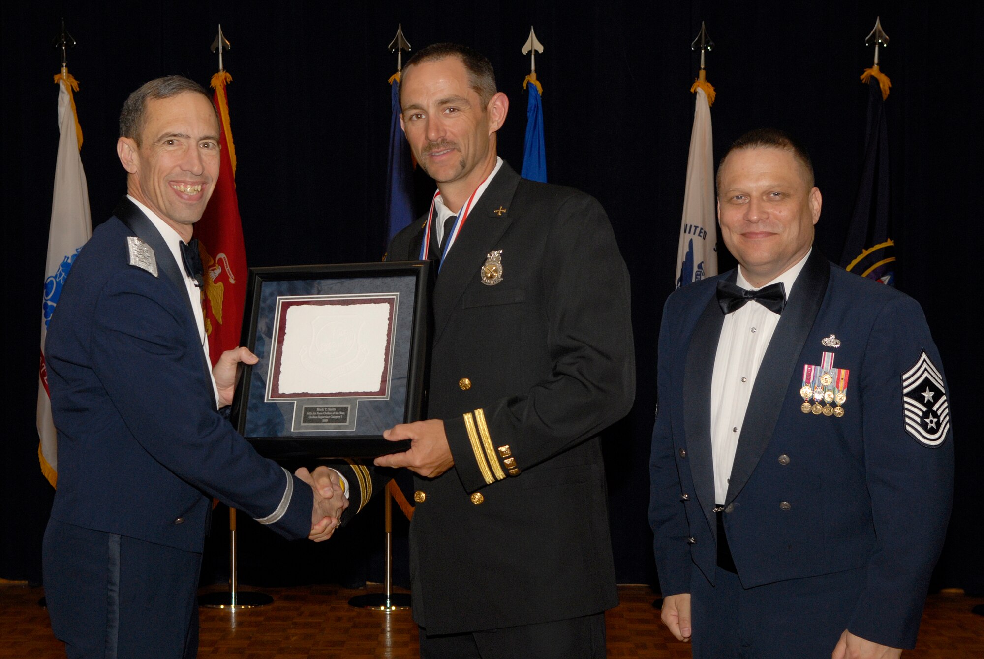 VANDENBERG AIR FORCE BASE, Calif. -- Mr. Mark Smith, with the 30th Civil Engineer Squadron, receives the 14th Air Force Civilian Supervisor Category 1 Annual Award from Lt. Gen. Larry James, the 14th Air Force commander, and Chief Master Sgt. James MacKinley, the 14th AF command chief master sergeant, during the 14th Air Force Annual Awards Ceremony at the Pacific Coast Club here Thursday, March 18, 2010.   (U.S. Air Force photo/Senior Airman Andrew Satran) 

 

 

 

 

 

 

 

 
 