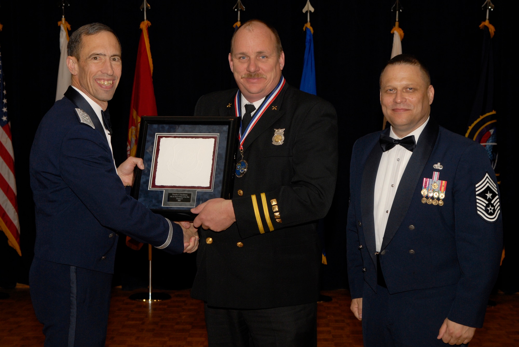 VANDENBERG AIR FORCE BASE, Calif. -- Mr. Timothy Sandstrom, with the 30th Civil Engineer Squadron, receives the 14th Air Force Civilian of the Year Category 2 Annual Award from Lt. Gen. Larry James, the 14th Air Force commander, and Chief Master Sgt. James MacKinley, the 14th AF command chief master sergeant, during the 14th Air Force Annual Awards Ceremony at the Pacific Coast Club here Thursday, March 18, 2010.   (U.S. Air Force photo/Senior Airman Andrew Satran) 

 

 

 

 

 

 

 
 