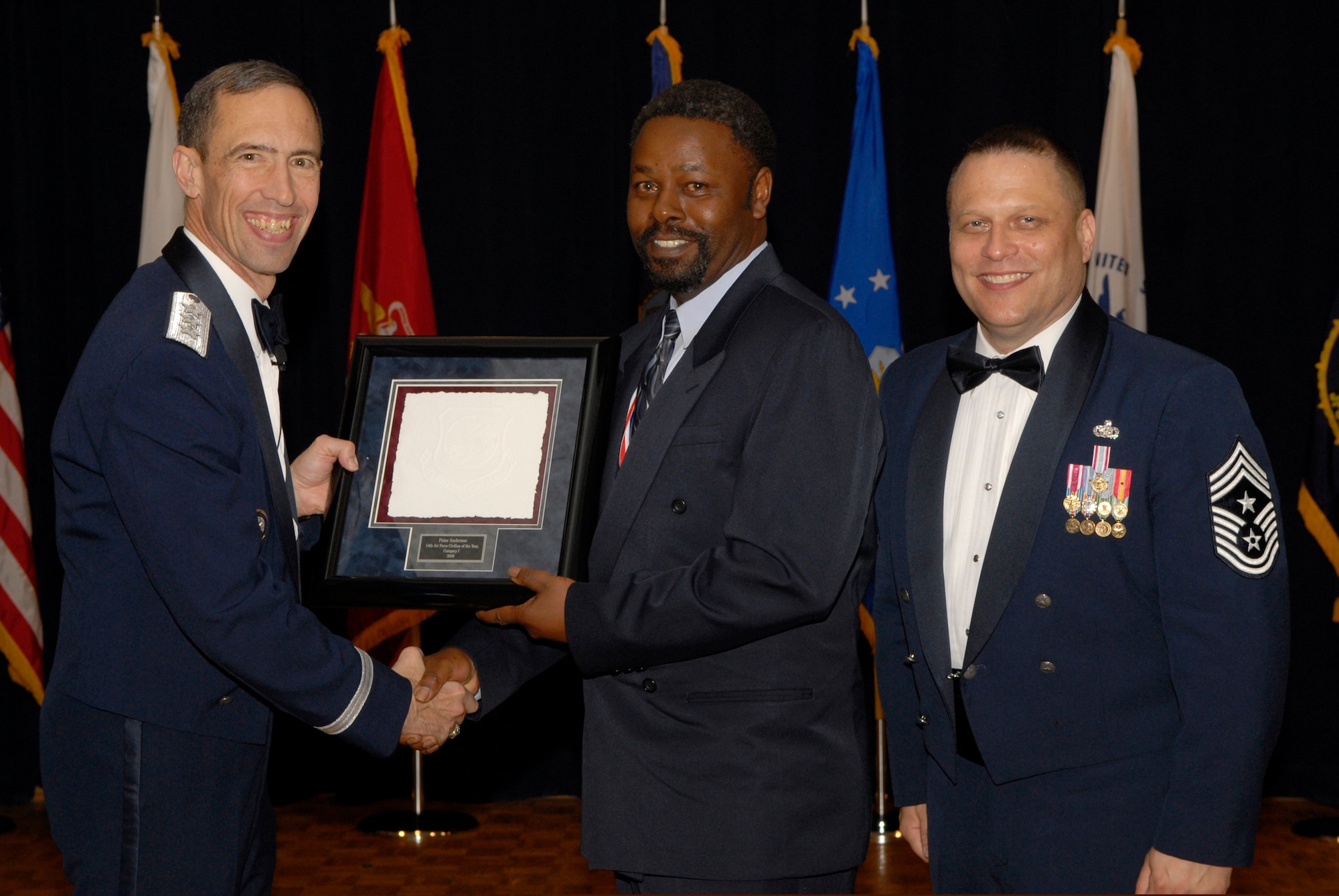 VANDENBERG AIR FORCE BASE, Calif. -- Mr. Peter Anderson, from the 21st Comptroller Squadron at Peterson Air Force Base, Colo., receives the 14th Air Force Civilian of the Year Category 1 Annual Award from Lt. Gen. Larry James, the 14th Air Force commander, and Chief Master Sgt. James MacKinley, the 14th AF command chief master sergeant, during the 14th Air Force Annual Awards Ceremony at the Pacific Coast Club here Thursday, March 18, 2010.   (U.S. Air Force photo/Senior Airman Andrew Satran) 

 

 

 

 

 

 
 