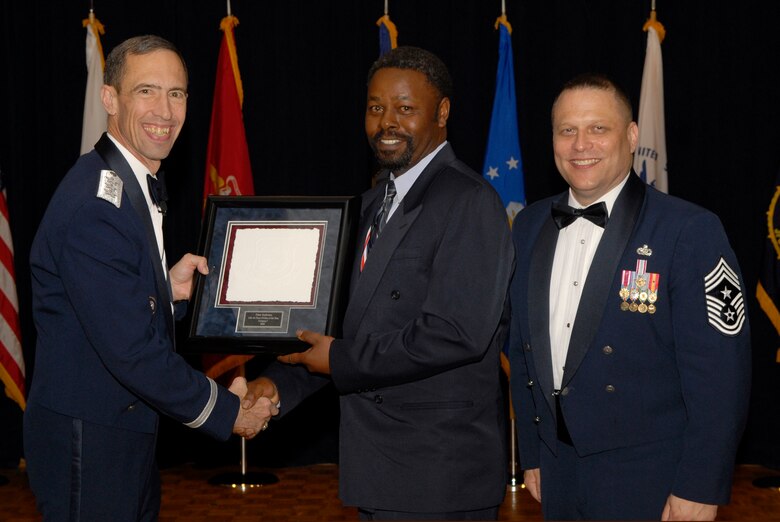 VANDENBERG AIR FORCE BASE, Calif. -- Mr. Peter Anderson, from the 21st Comptroller Squadron at Peterson Air Force Base, Colo., receives the 14th Air Force Civilian of the Year Category 1 Annual Award from Lt. Gen. Larry James, the 14th Air Force commander, and Chief Master Sgt. James MacKinley, the 14th AF command chief master sergeant, during the 14th Air Force Annual Awards Ceremony at the Pacific Coast Club here Thursday, March 18, 2010.   (U.S. Air Force photo/Senior Airman Andrew Satran) 

 

 

 

 

 

 
 