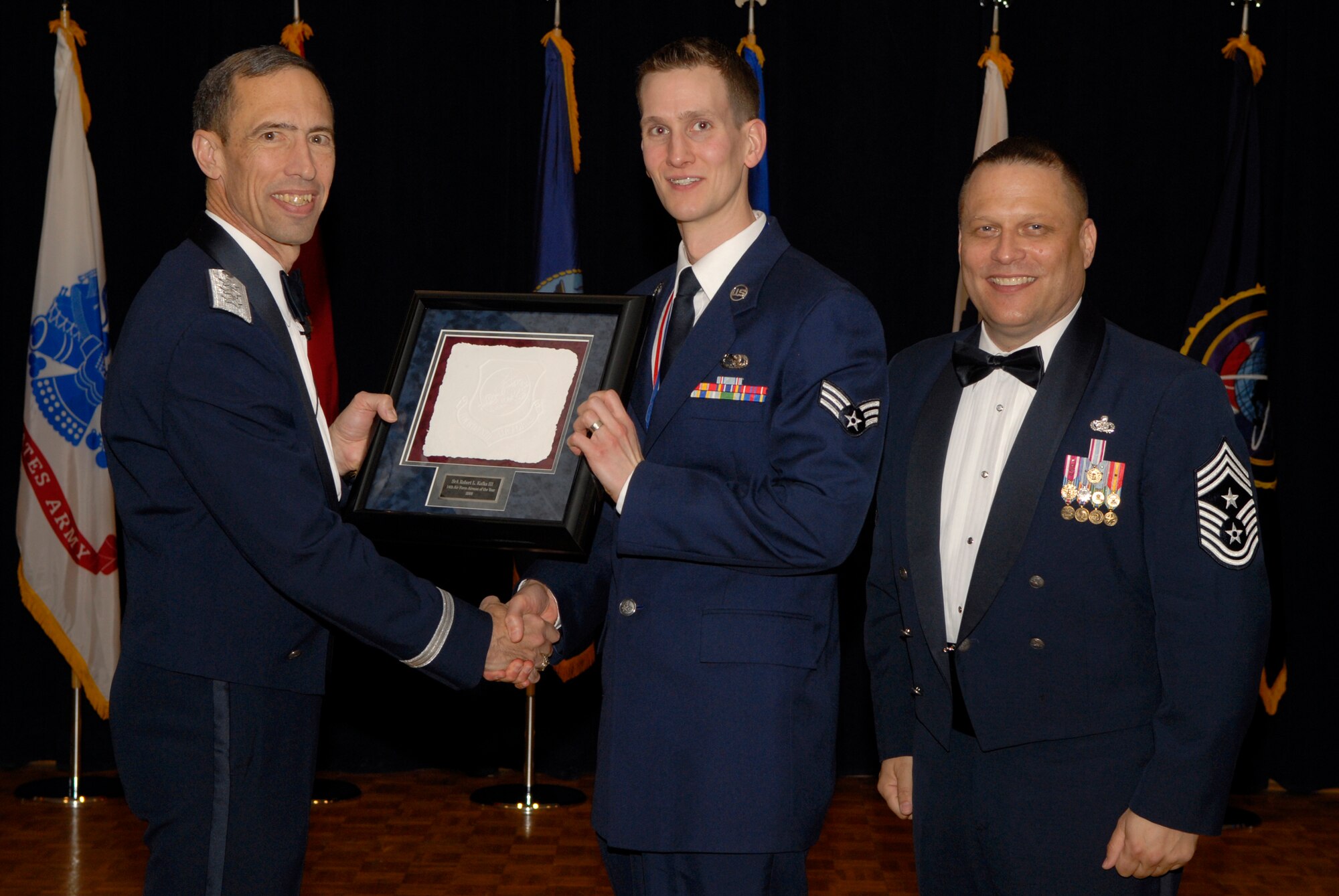 VANDENBERG AIR FORCE BASE, Calif. -- Senior Airman Robert Kafka, with the 460th Space Communications Squadron at Buckley Air Force Base, Colo., receives the 14th Air Force Airman of the Year Annual Award from Lt. Gen. Larry James, the 14th Air Force commander, and Chief Master Sgt. James MacKinley, the 14th AF command chief master sergeant, during the 14th Air Force Annual Awards Ceremony at the Pacific Coast Club here Thursday, March 18, 2010.   (U.S. Air Force photo/Senior Airman Andrew Satran) 

 

 

 

 
 