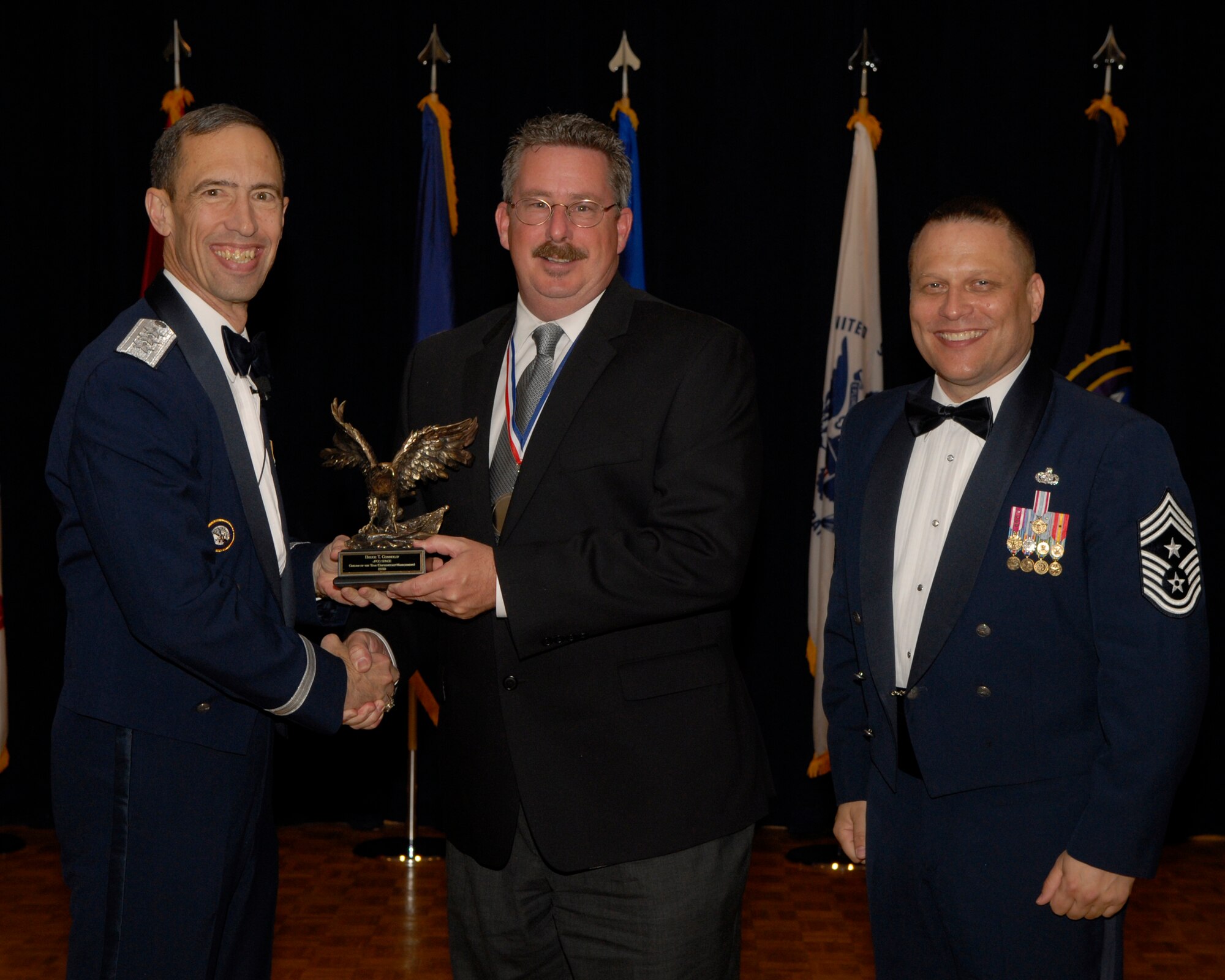 VANDENBERG AIR FORCE BASE, Calif. -- Mr. Bruce Connolly, with the Joint Functional Component Command for Space, receives the JFCC Space Supervisor-Management Civilian Category Annual Award from Lt. Gen. Larry James, the 14th Air Force commander, and Chief Master Sgt. James MacKinley, the 14th AF command chief master sergeant, during the 14th Air Force Annual Awards Ceremony at the Pacific Coast Club here Thursday, March 18, 2010.   (U.S. Air Force photo/Senior Airman Andrew Satran) 

 

 

 
 