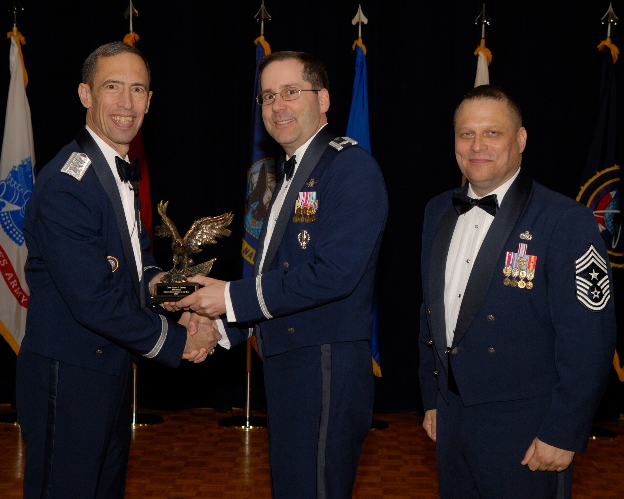 VANDENBERG AIR FORCE BASE, Calif. -- Capt. Scott Drylie, with the Joint Functional Component Command for Space, receives the JFCC Space Company Grade Officer Annual Award from Lt. Gen. Larry James, the 14th Air Force commander, and Chief Master Sgt. James MacKinley, the 14th AF command chief master sergeant, during the 14th Air Force Annual Awards Ceremony at the Pacific Coast Club here Thursday, March 18, 2010.   (U.S. Air Force photo/Senior Airman Andrew Satran) 

 

 

 

 