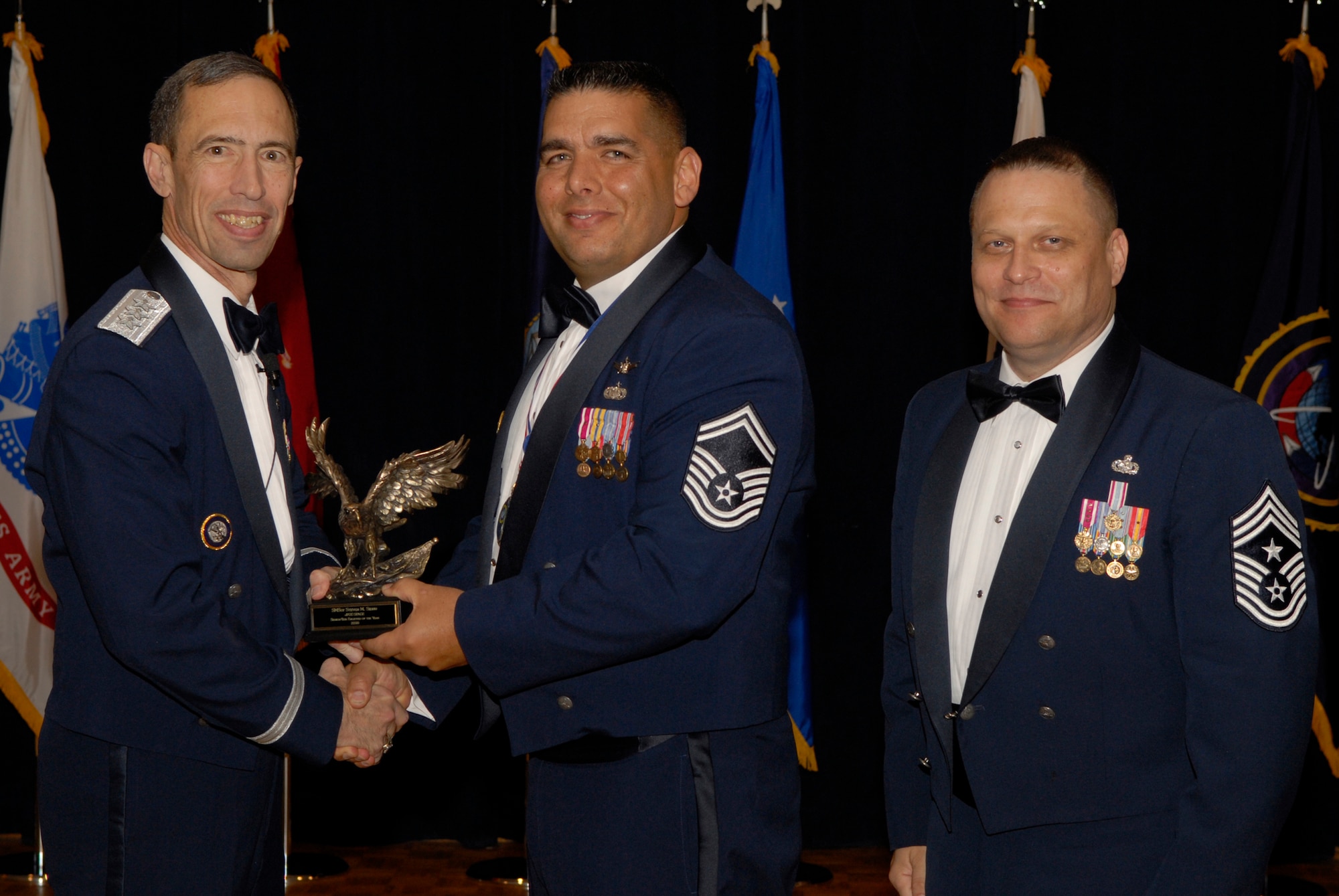 VANDENBERG AIR FORCE BASE, Calif. -- Senior Master Sgt. Steven Sidhu, with the Joint Functional Component Command for Space, receives the JFCC Space Senior-Tier Enlisted Annual Award from Lt. Gen. Larry James, the 14th Air Force commander, and Chief Master Sgt. James MacKinley, the 14th AF command chief master sergeant, during the 14th Air Force Annual Awards Ceremony at the Pacific Coast Club here Thursday, March 18, 2010.   (U.S. Air Force photo/Senior Airman Andrew Satran) 

 

 

 