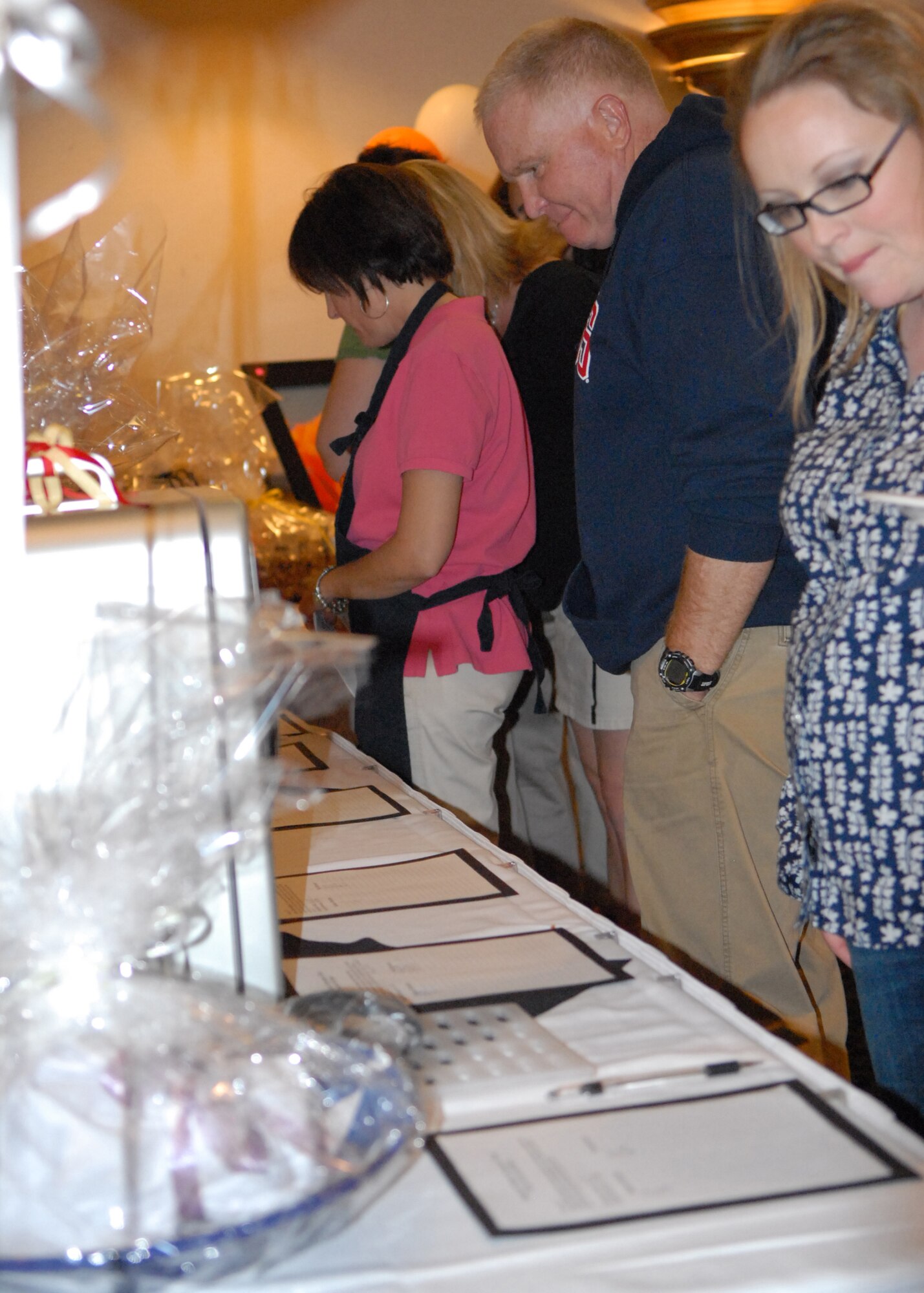 Airmen participate in the 9th Annual Mad Marchness Annual Charity and Fundraising Auction. The auction, which was hosted by Edwards Officer's Spouses Club, was attended by more than 130 people. (Air Force photo/Meredith Mingledorff)