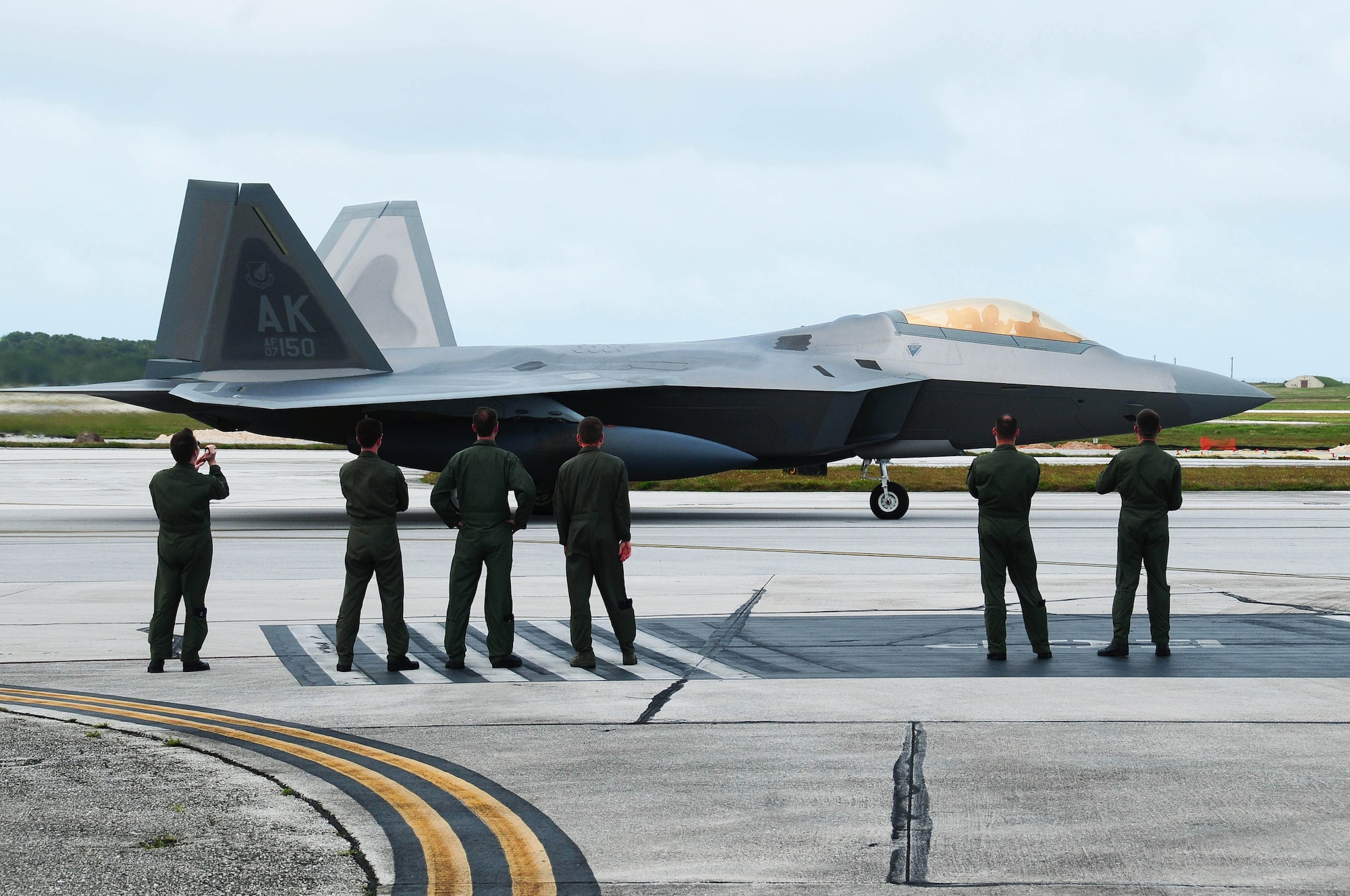 ANDERSEN AIR FORCE BASE, Guam -- F-22 Raptor pilots deployed from Elmendorf Air Force Base, Alaska, welcome fellow aircraft to Andersen Air Force Base, Guam, Jan. 18. Andersen received 12 of the $140 million advanced aircraft along with more than 200 Airmen to begin a three month deployment as part of the Theater Security Package. The fifth generation fighter, along with associated maintenance and support personnel, are deployed as the 90th Expeditionary Fighter Squadron and will participate in various training missions while on island. (U.S. Air Force photo by Airman 1st Class Jeffrey Schultze)

