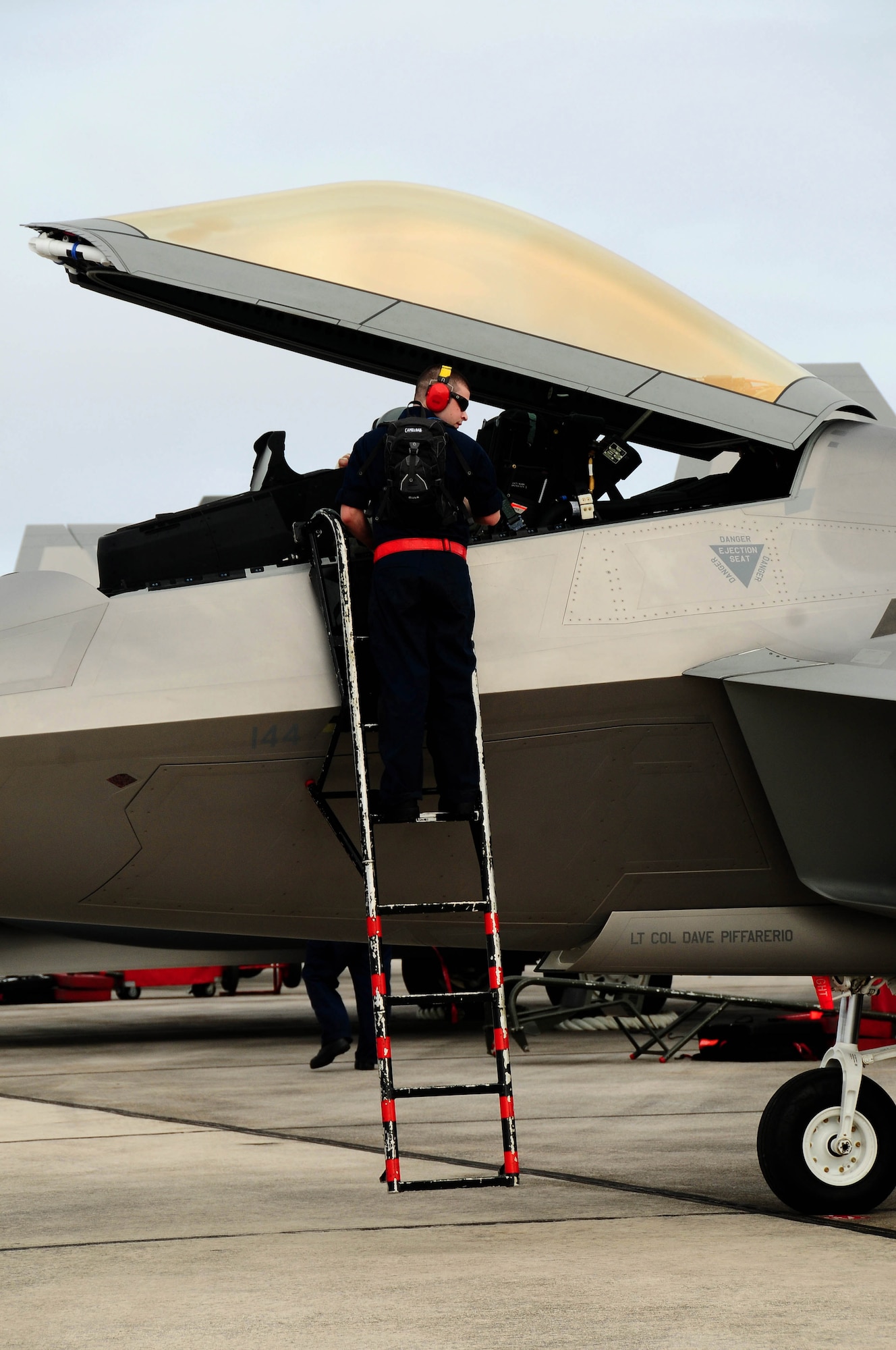 ANDERSEN AIR FORCE BASE, Guam ? An F-22 Maintainer performs a post  flight check on one of deployed  fighters from Elmendorf Air Force Base, Alaska, here, Jan. 18. Andersen received 12 of the $140 million advanced aircraft along with more than 200 Airmen to begin a three month deployment as part of the Theater Security Package. The fifth generation fighter, along with associated maintenance and support personnel, are deployed as the 90th Expeditionary Fighter Squadron and will participate in various training missions while on island. (U.S. Air Force photo by Airman 1st Class Jeffrey Schultze)

