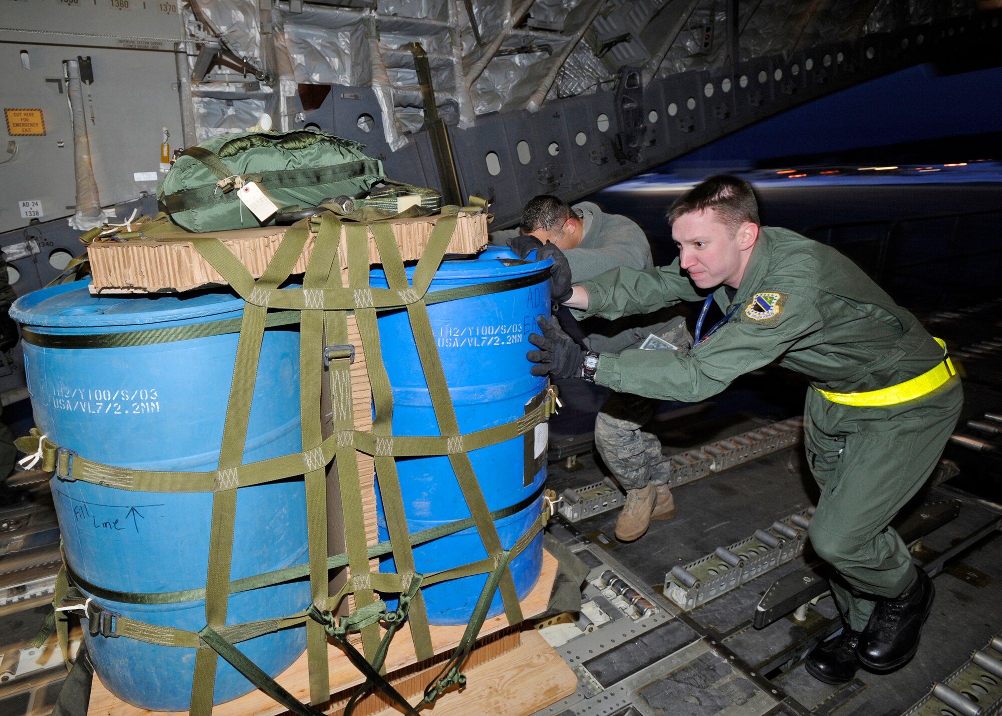 ELMENDORF AIR FORCE BASE, Alaska -- Staff Sgt. Chris McKnight and members of the 517th Aircraft Maintenance Unit, load a water crate on to a C-17 Globemaster III March 19. Sergeant McKnight and his crew from the 517th Airlift Squadron were participating in a combat simulation improved container delivery drop over Tin City, Alaska. (Air Force photo by Senior Airman Matt Coleman-Foster)