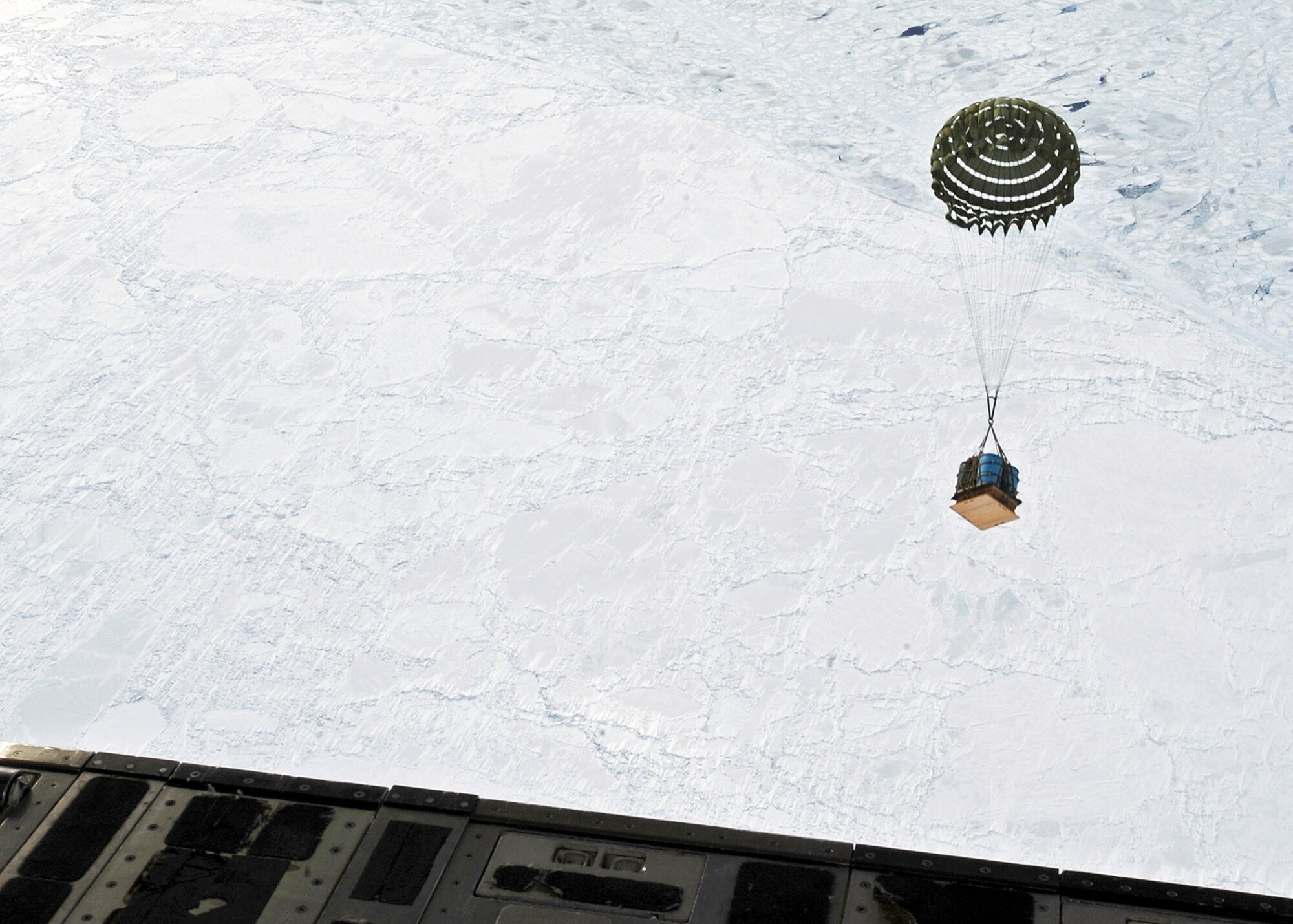 ELMENDORF AIR FORCE BASE, Alaska -- A crate of water is dropped from a C-17 Globemaster from the 517th Airlift Squadron March 19. The 517th AS was participating in a combat simulation improved container delivery drop over Tin City, Alaska. (Air Force photo by Senior Airman Matt Coleman-Foster)