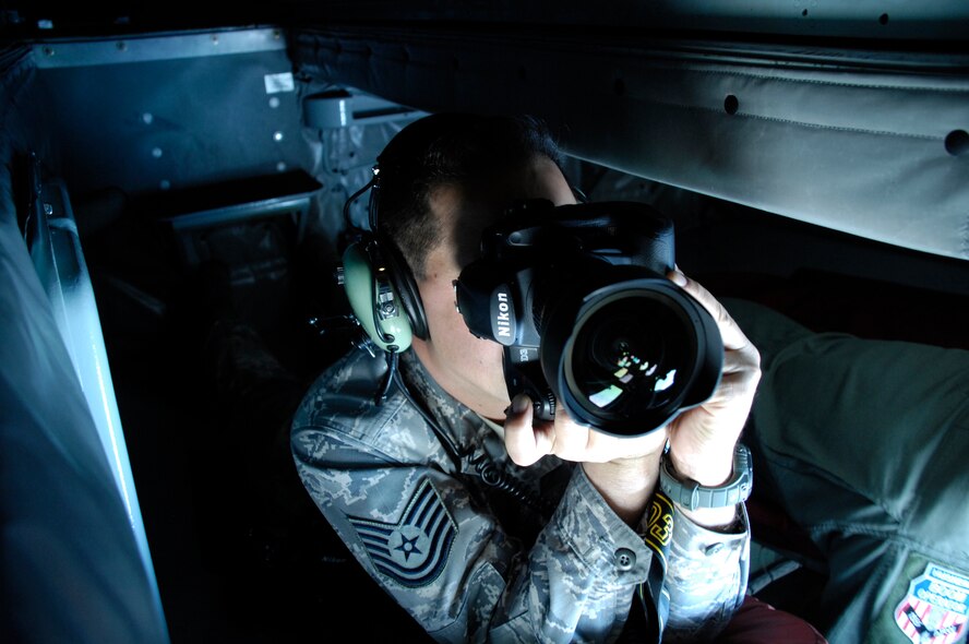 NELLIS AIR FORCE BASE, Nev. -- Tech. Sgt. Chris Flahive, 49th Fighter Wing Public Affairs photographer, photographs an in-flight refuel from a KC-135 during Red Flag 10-3, March 1, 2010. Sergeant Flahive recently received first place in the picture story category of the Air Combat Command Media Contest. (U.S. Air Force photo by Staff Sgt. Sanjay Allen)