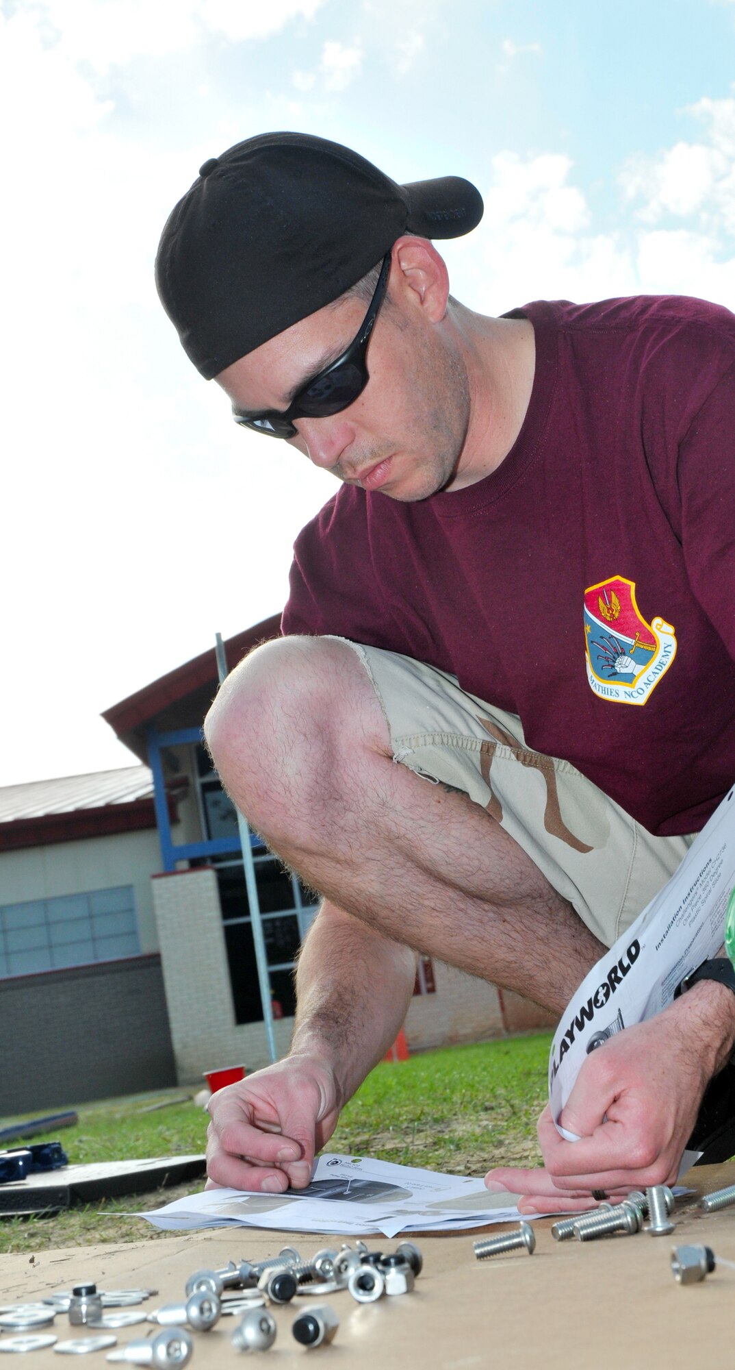 Tech. Sgt. Barry Pope, from the Mathies NCO Academy, worked on installation of playground equipment.  Officials said the large volunteer turnout saved the school $7,500 in construction costs and helped complete the project in half the expected time.  (U.S. Air Force photo by Adam Bond)
