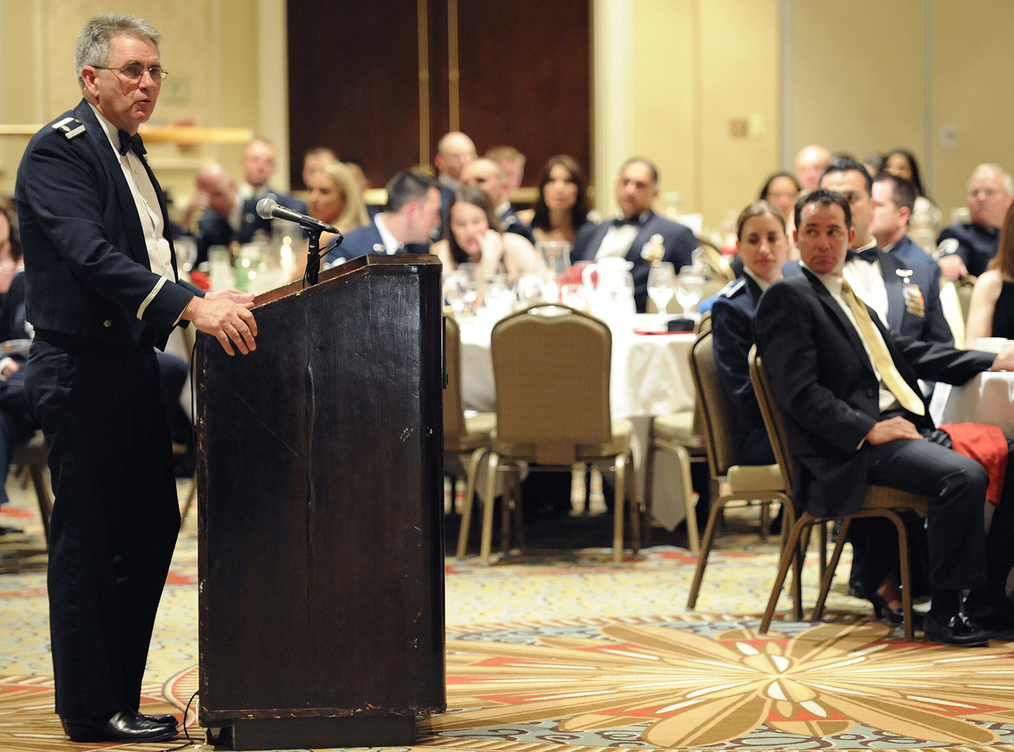 Lt. Col. (ret.) Robert Holliker, Jr., delivers an inspirational speech to the crowd March 6 during the 302nd Airlift Wing's annual awards banquet at the Antlers Hitlon in downtown Colorado Springs, Colo. The awards banquet honored the wing's top Airman, non-commissioned officer, senior non-commissioned officer and company grade officer respectively. (U.S. Air Force photo/Craig Denton)