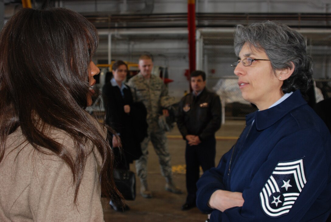 Command Chief Master Sgt. Sandra Santos, the highest-ranking enlisted member of the 932nd Airlift Wing, tells a visitor how the Air Force Reserve Command's only flying wing in Illinois works.  She also spoke at a special luncheon recently honoring women.  (U.S. Air Force photo/Maj. Stan Paregien)