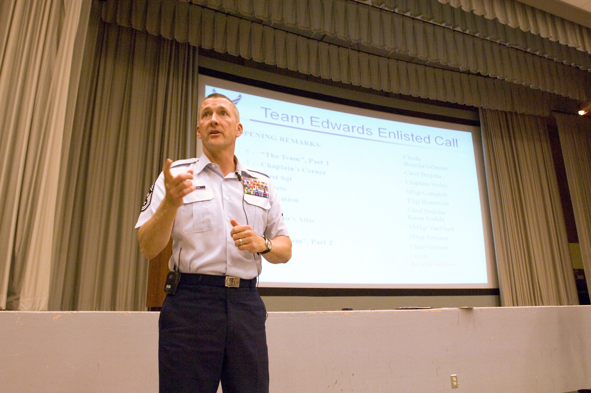 Chief Master Sgt.  Mark Brejcha, 412th Test Wing command chief, addresses Edwards enlisted force March 19 at the Base Theater. The enlisted call helps update enlisted Airmen on training, concerns and policy. (Air Force photo/Edward Cannon)