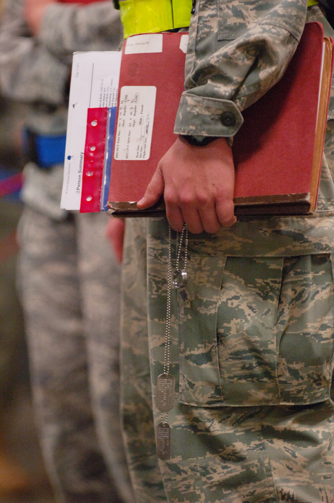 SCOTT AIR FORCE BASE, Ill. – Airmen stand in the personnel deployment function line with their dog tags and required documents needed to process them through the line during the initial stages of the Operational Readiness Inspection, March 23, 2010. The 375th Air Mobility Wing is being graded by the Air Mobility Command inspector general to ensure they are able to respond to a global threat and deploy combat ready Airmen at a moments notice. (U.S. Air Force photo by/ Senior Airman Ryan Crane)