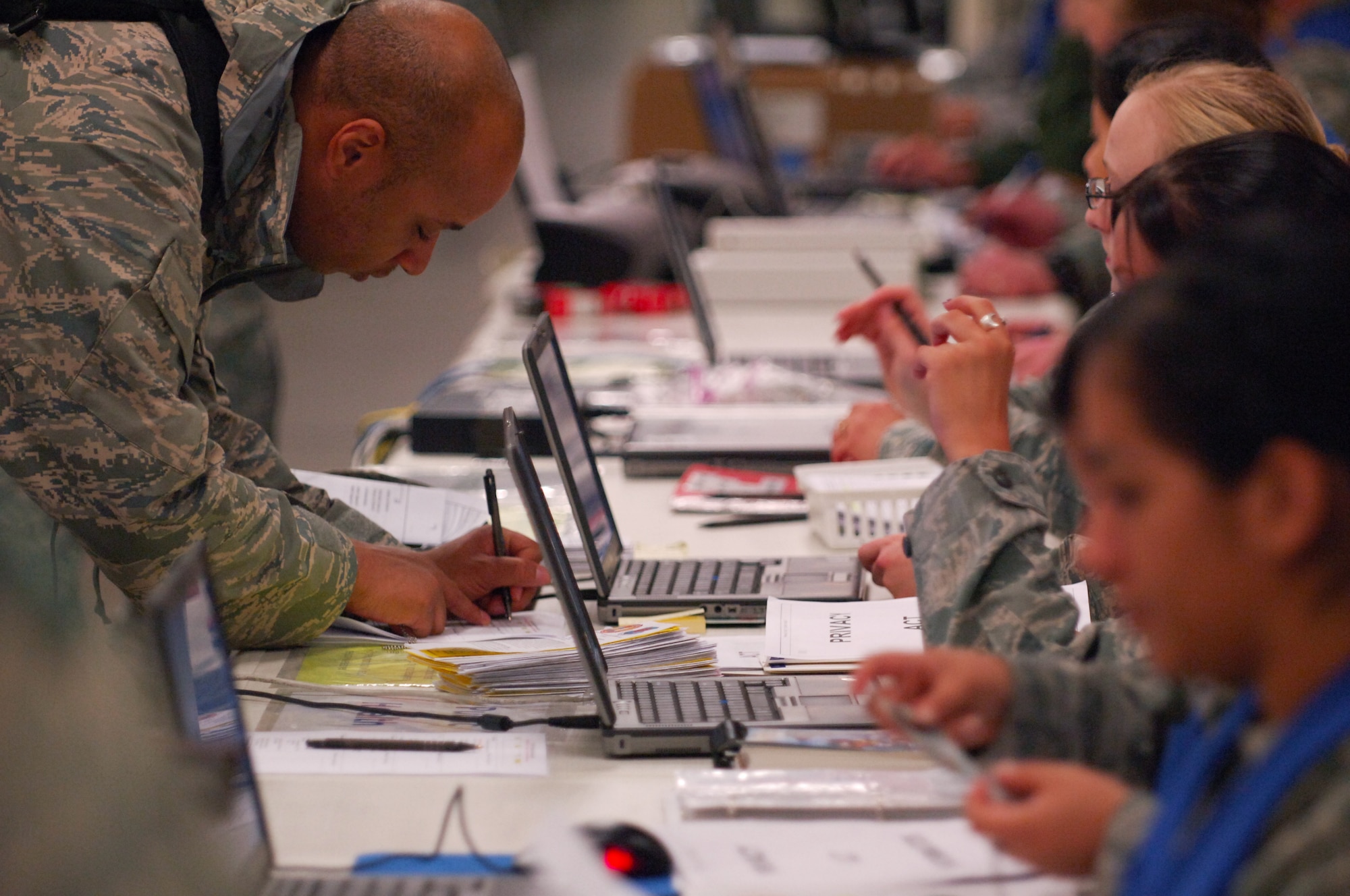 SCOTT AIR FORCE BASE, Ill. – Airmen process through the personnel deployment function line during the initial stages of the Operational Readiness Inspection, March 23, 2010. The 375th Air Mobility Wing is being graded by the Air Mobility Command inspector general to ensure they are able to respond to a global threat and deploy combat ready Airmen at a moments notice. (U.S. Air Force photo by Senior Airman Ryan Crane)