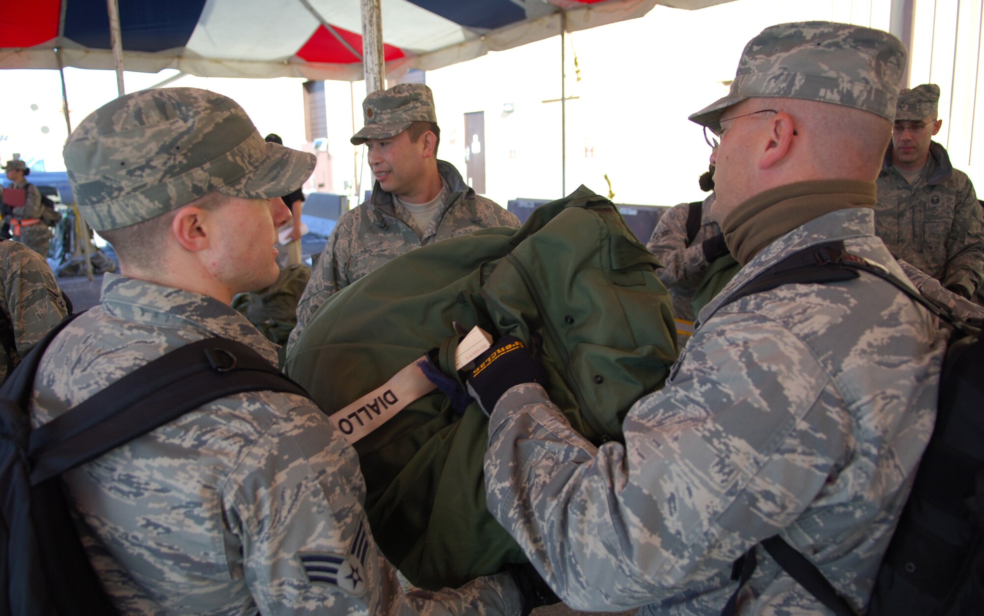 SCOTT AIR FORCE BASE, Ill. – 375th Medical Group personnel pass mobility bags down a line to be stacked onto a pallet that will be flown to their simulated deployed location during the initial stages of the Operational Readiness Inspection, March 23, 2010. The 375th Air Mobility Wing is being graded by the Air Mobility Command inspector general to ensure they are able to respond to a global threat and deploy combat ready Airmen at a moments notice. (U.S. Air Force photo by Senior Airman Ryan Crane)