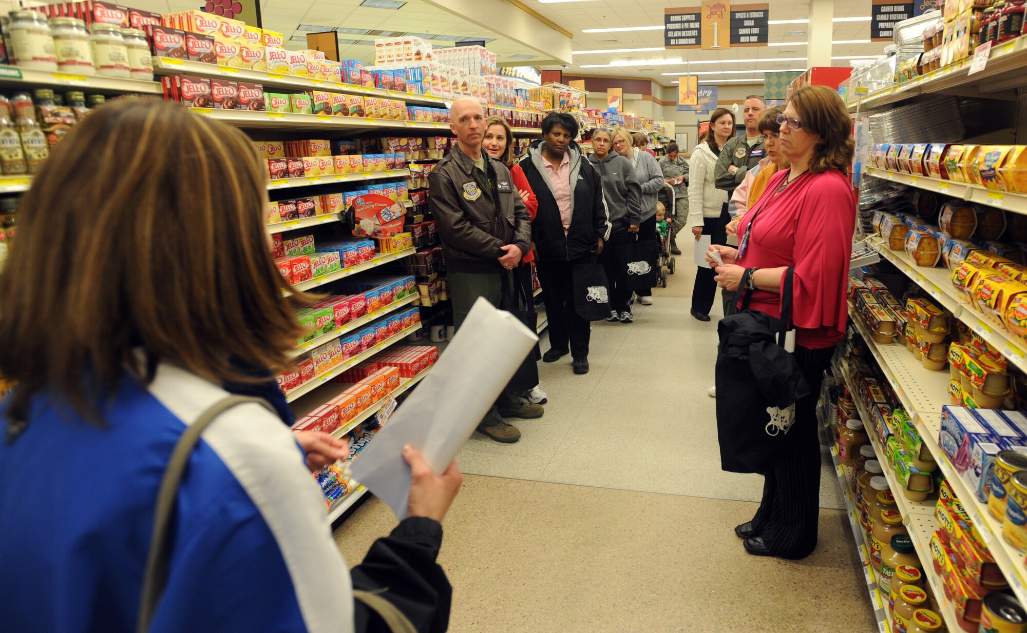Tour participants listen to helpful tips on how to choose healthy foods at the 319th Air Refueling Wing Health and Wellness Center’s base commissary tour March 23. (U.S. Air Force photo by Staff Sgt. Suellyn F. Nuckolls)