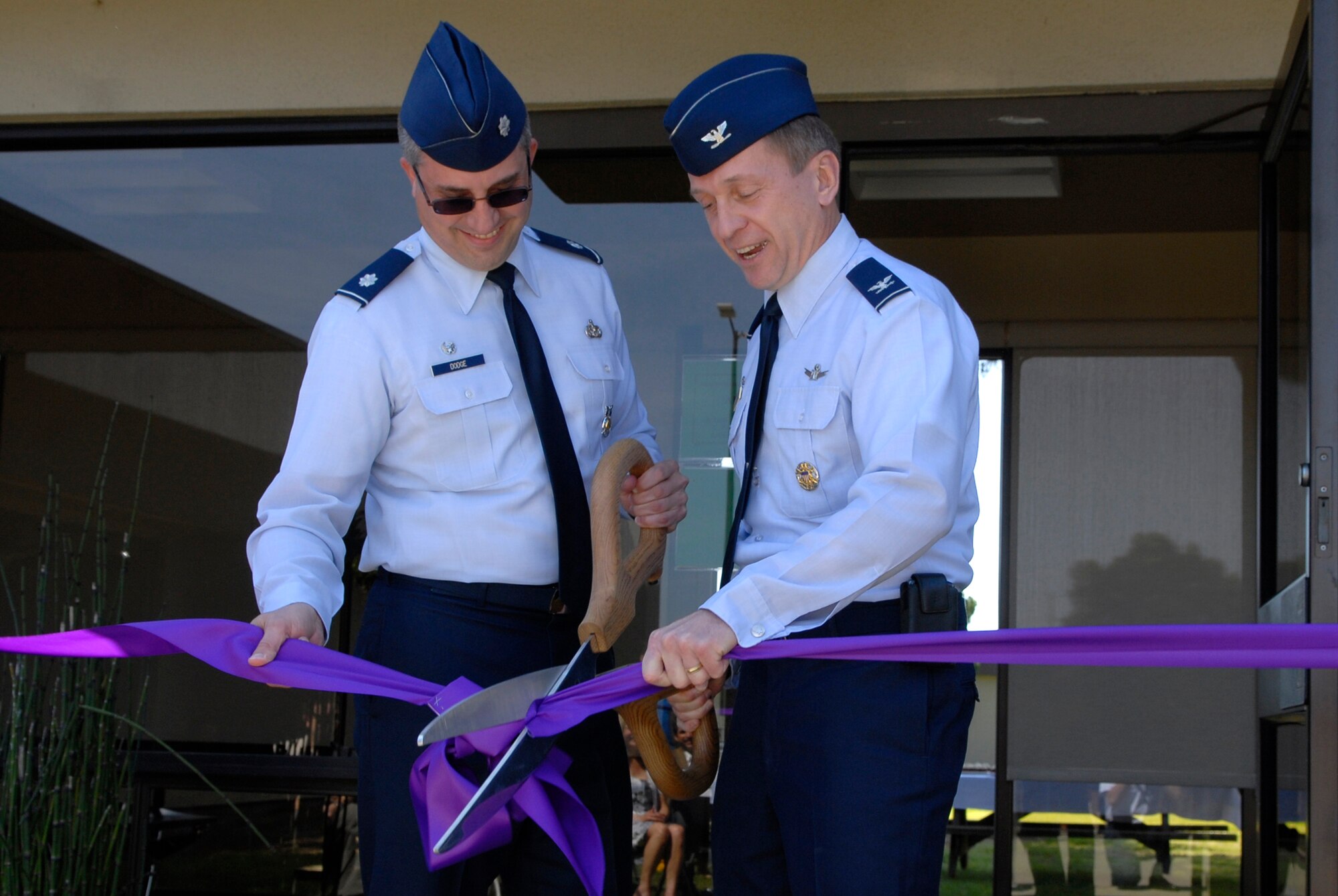 VANDENBERG AIR FORCE BASE, Calif. -- Col. David Buck, the 30th Space Wing commander, and Lt. Col. Timothy Dodge, the 30th Civil Engineer Squadron commander, cut the ribbon celebrating the opening of a remodeled 30th CES facility during a ceremony here Monday, March 22, 2010. (U.S. Air Force photo/Senior Airman Andrew Satran) 

 
 