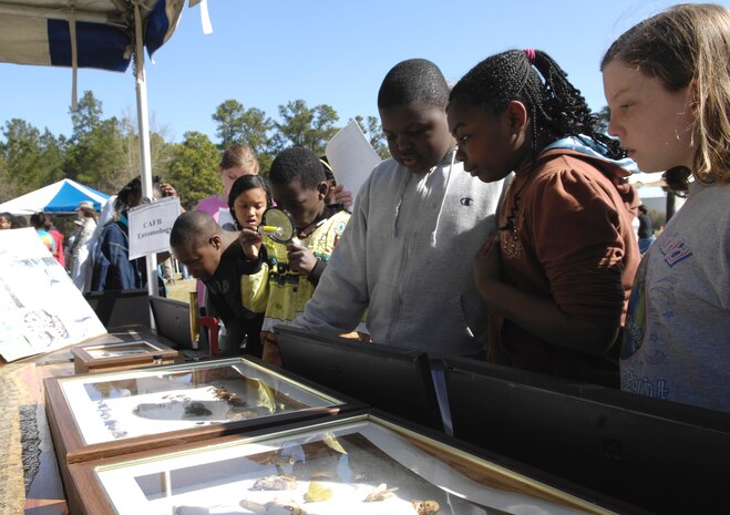 Students from Hunley Park Elementary School observe glass cases filled with preserved bugs at the entomology booth during the 14th annual Earth Day festival held on Joint Base Charleston, S.C., March 24, 2010. The students rotated through 27 different booths that were manned by different organizations that protect South Carolina's wildlife and environment. Eight different elementary schools attended the event with approximately 700 students total. (U.S. Air Force Photo/Airman 1st Class Lauren Main)