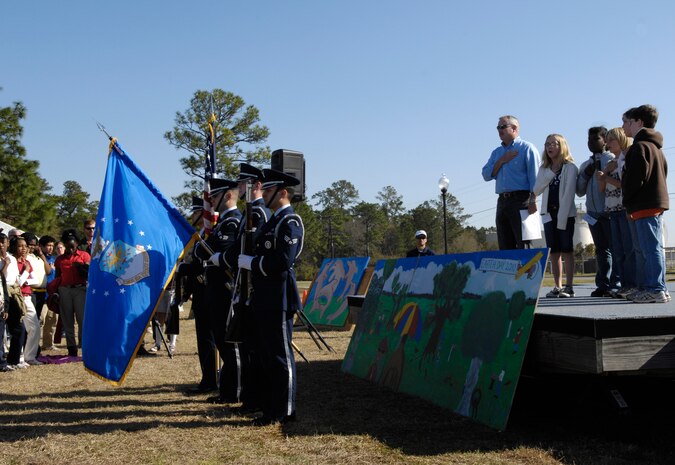 The base honor guard presents the colors as five students from various elementary schools lead the group in reciting the Pledge of Allegiance during the 14th annual Earth Day festival held on Joint Base Charleston S.C., March 24, 2010. Approximately 700 students attended the event from eight different tri county area elementary schools. During the festival the students rotated through 27 different booths and learned about the environment, South Carolina's wildlife and ways to protect it. (U.S. Air Force Photo/Airman 1st Class Lauren Main)