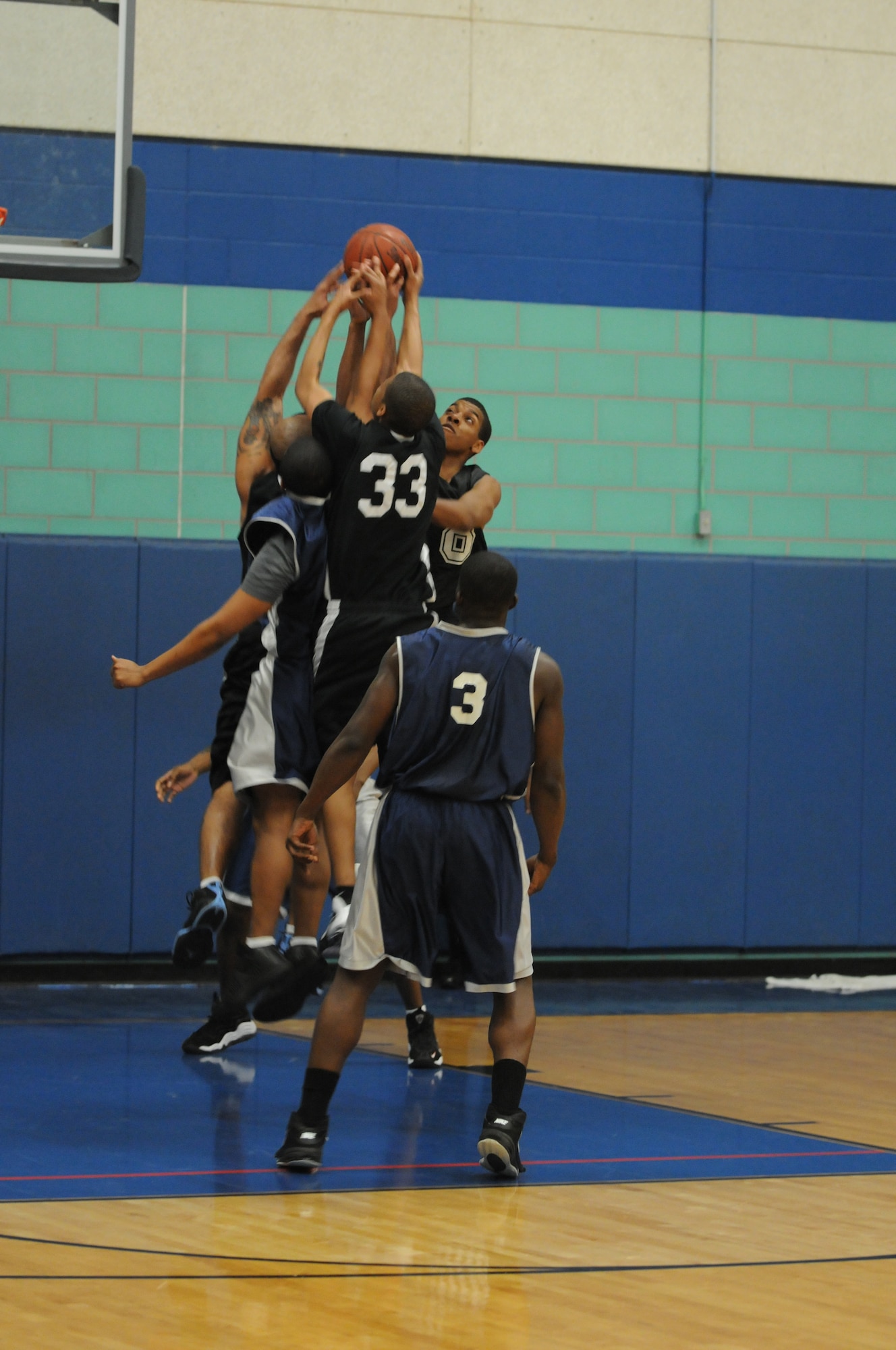 GOODFELLOW AIR FORCE BASE, Texas -- Members from the Goodfellow  and Dyess Air Force Base  varsity basketball teams try to gain control of the ball during the match, March 19, 2010. Goodfellow has two more home games, March 27 and 28, both against Randolph. (U.S. Air Force photo/Airman 1st Class Clayton Lenhardt)