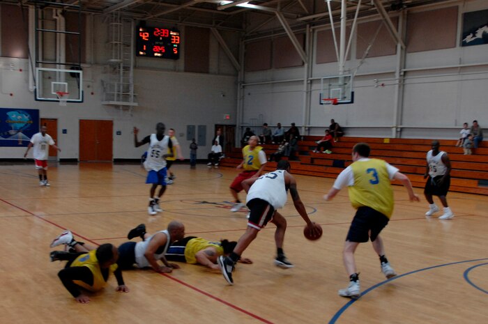 U.S. Army Pfc. Antonio Epps breaks away with the ball after a pile up during an intramural basketball game held at the Fitness and Sports Center March 23, 2010, at Joint Base Charleston, S.C. The 16th Airlift Squadron beat the 4th and 1/18th Infantry Division Army basketball team 47-37. (U.S. Air Force photo/Senior Airman Timothy Taylor)