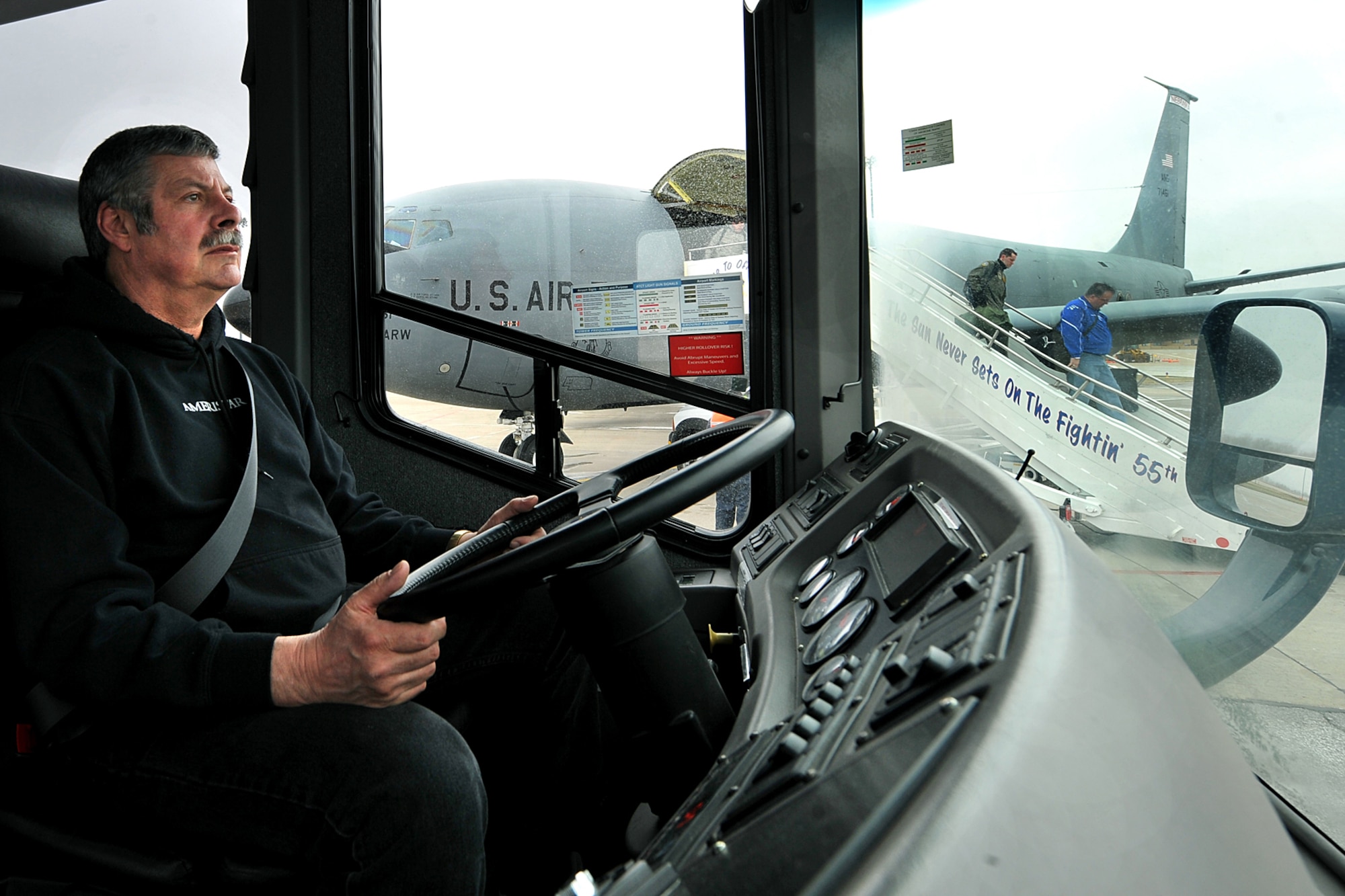 OFFUTT AIR FORCE BASE, Neb. -- Dan McDermott, a driver with the 55th Mission Support Group's Logistics Support Division, waits for members of U.S. Strategic Command to board a bus after landing at Offutt aboard a KC-135 March 19. The division's vehicle operations section takes care of Offutt's transportation needs using a fleet of more than 60 vehicles.  

U.S. Air Force photo by Charles Haymond