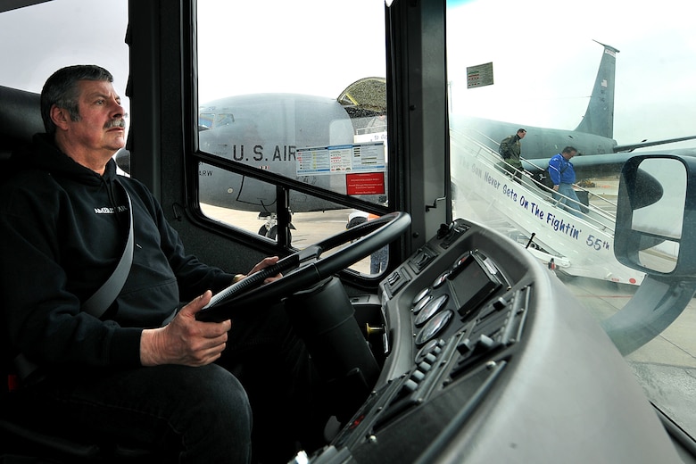 OFFUTT AIR FORCE BASE, Neb. -- Dan McDermott, a driver with the 55th Mission Support Group's Logistics Support Division, waits for members of U.S. Strategic Command to board a bus after landing at Offutt aboard a KC-135 March 19. The division's vehicle operations section takes care of Offutt's transportation needs using a fleet of more than 60 vehicles.  

U.S. Air Force photo by Charles Haymond