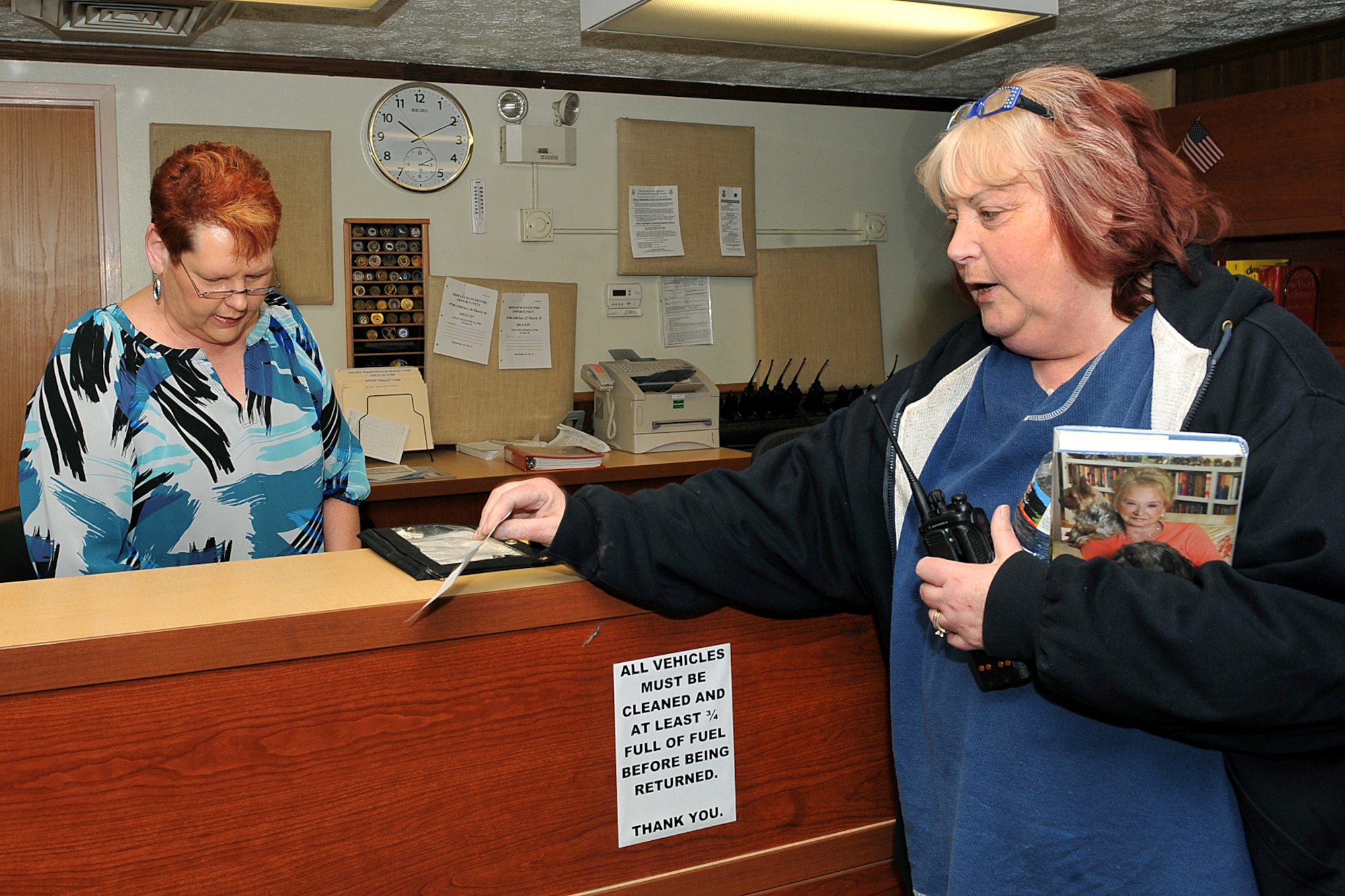 OFFUTT AIR FORCE BASE, Neb. - (From left) Dispatcher Betty McCubbin gives keys to base shuttle driver Sheila Wilen-Paulus before shift change inside the vehicle operations office March 19. Both Ms. McCubbin and Ms. Wilen-Paulus are part of the 55th Mission Support Group's Logistics Support Division. The division's vehicle operations section takes care of Offutt's transportation needs using a fleet of more than 60 vehicles.  

U.S. Air Force photo by Charles Haymond