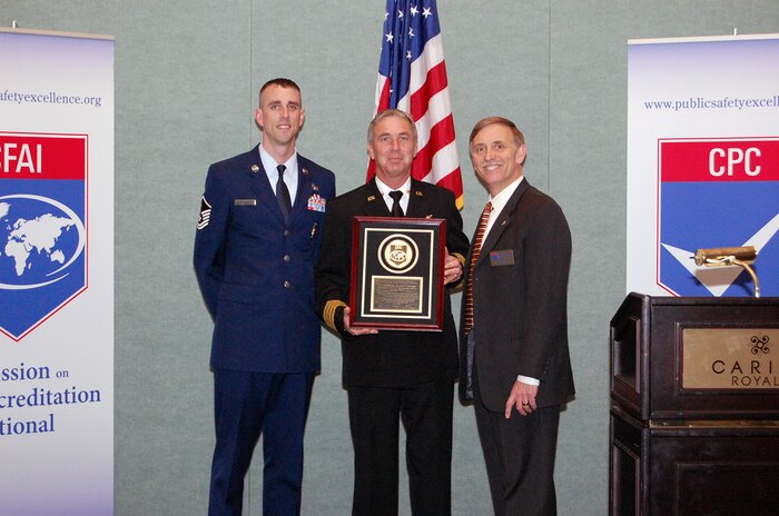 Master Sgt. Michael Patterson, left, and James Copeland, center, receive an official plaque from Ernst Piercy, displaying their recent accreditation by the Commission on Fire Accreditation International in Orlando, Fla. The CFAI operates to improve the quality of fire and emergency medical services and enhance the careers of public safety professionals. Sergeant Patterson is the assistant chief of training for the 628th Civil Engineer Squadron Fire Emergency Services Flight, Mr. Copeland is flight's deputy fire chief and Mr. Piercy is the Air Force Academy fire chief and Department of Defense representative for the CFAI commission. (Courtesy photo)
