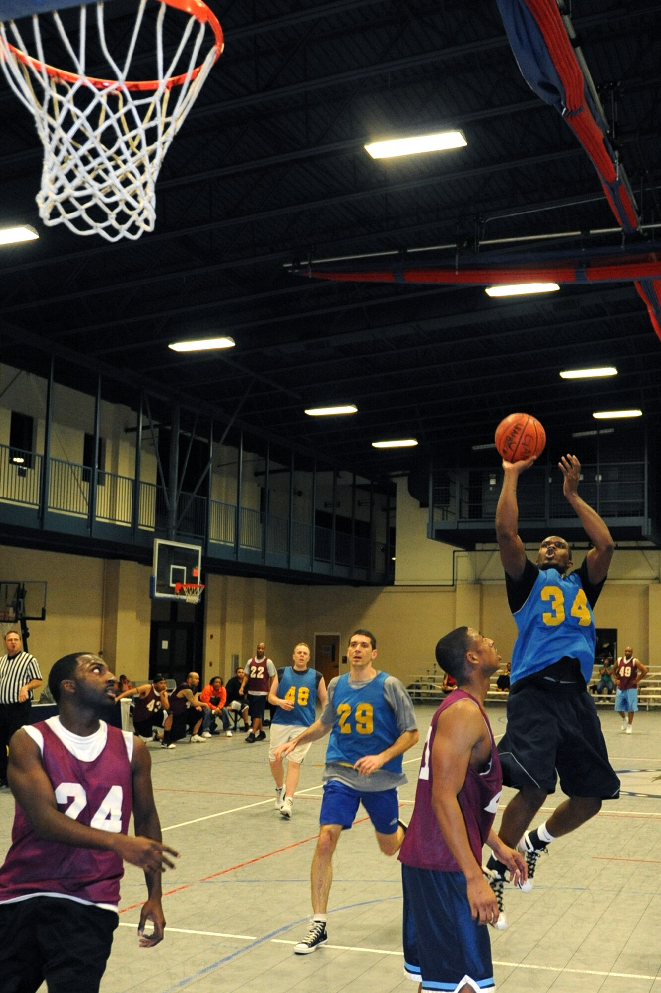 Joshua Payne, 19th Airlift Wing Staff, floats a jumper over Brandon Barnes, 19th Force Support Squadron, during the base basketball intramural championship March 19 at the fitness center. (U.S. Air Force photo by Senior Airman Ethan Morgan)