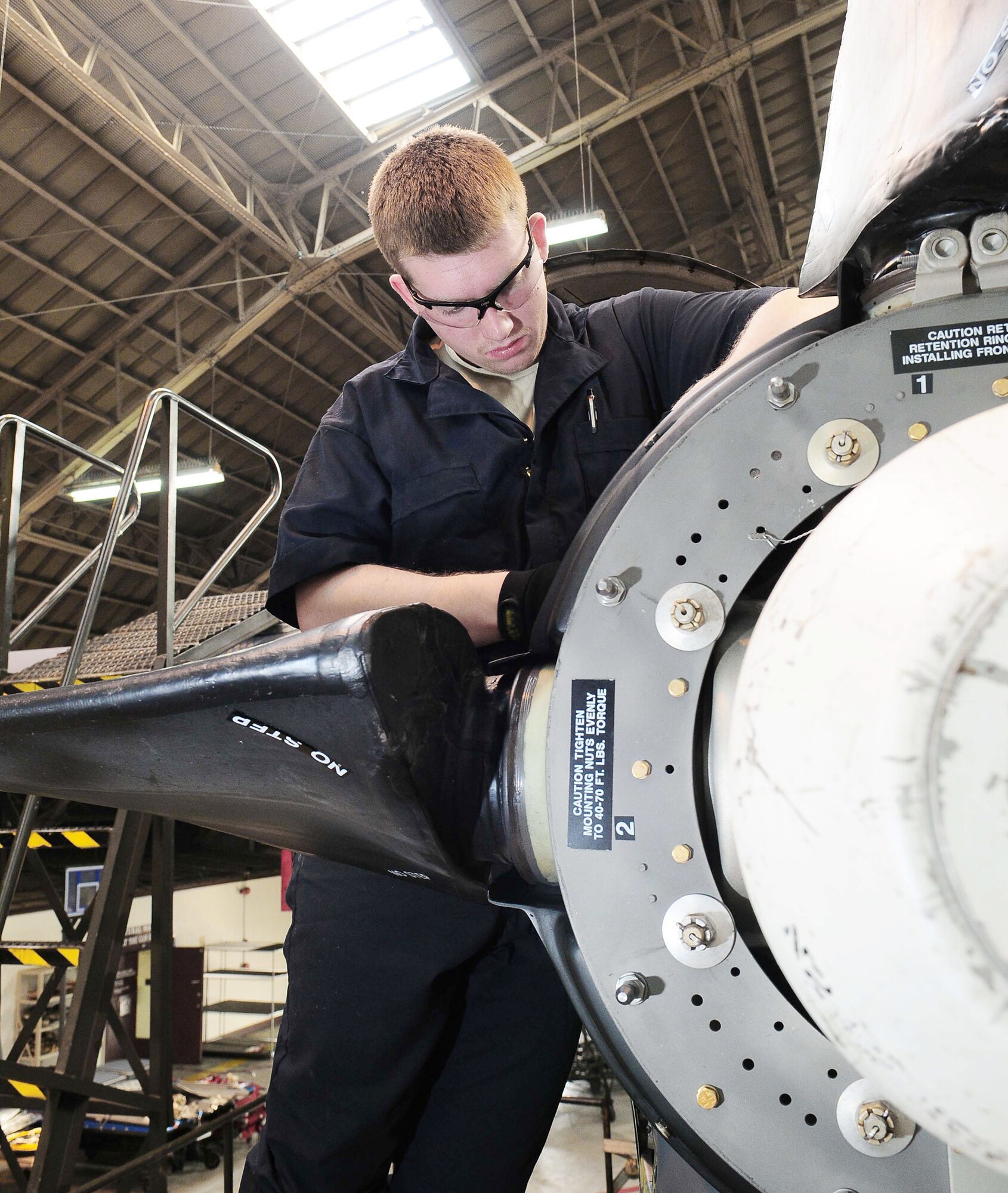 Airman 1st Class Garrick Kanen replaces a brush block on the engine of a C-130 Hercules March 16, 2010, at Yokota Air Base, Japan. Each plane undergoes an isochronal inspection that consists of a 14-day detailed inspection before the plane is ready for re-launch. Airman Kanen is assigned to the 374th Maintenance Squadron. (U.S. Air Force photo/Airman 1st Class Devin Doskey)