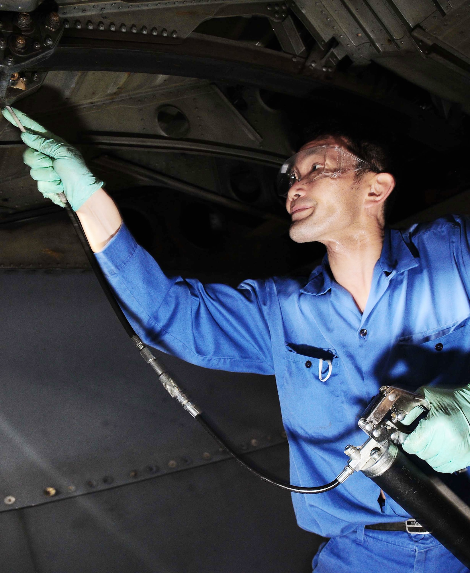 Toshio Shimida lubes a flap track on a C-130 Hercules March 16, 2010, at Yokota Air Base, Japan. Each plane undergoes an isochronal inspection which consists of a 14-day detailed inspection before the plane is ready for re-launch. Mr. Shimida is assigned to the 374th Maintenance Squadron. (U.S. Air Force photo/Airman 1st Class Devin Doskey)