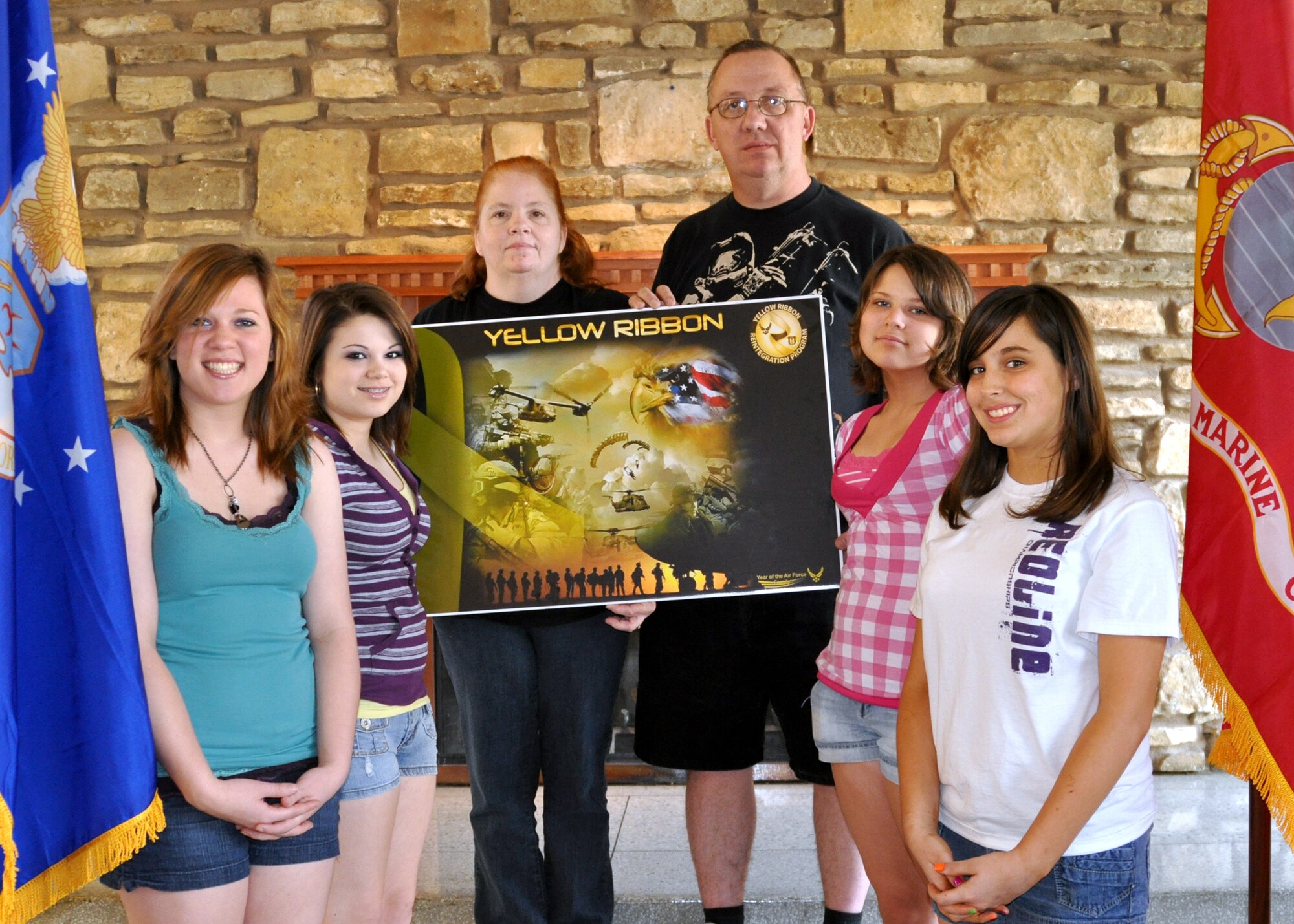 Tech. Sgt. Melvin Cargill, a security forces team leader for the 917th Security Forces Squadron on Barksdale Air Force Base, La., takes time to stand beside his wife and four daughters for a photograph at a Yellow Ribbon Reintegration Program event March 19, 2010. The 917th Wing attended and aided in staffing the YRRP at the American Airlines Training and Conference Center in Fort Worth, Texas, March 19, 2010 through March 21, 2010. (U.S. Air Force Photo/Senior Airman Crystal Marie Jordan)