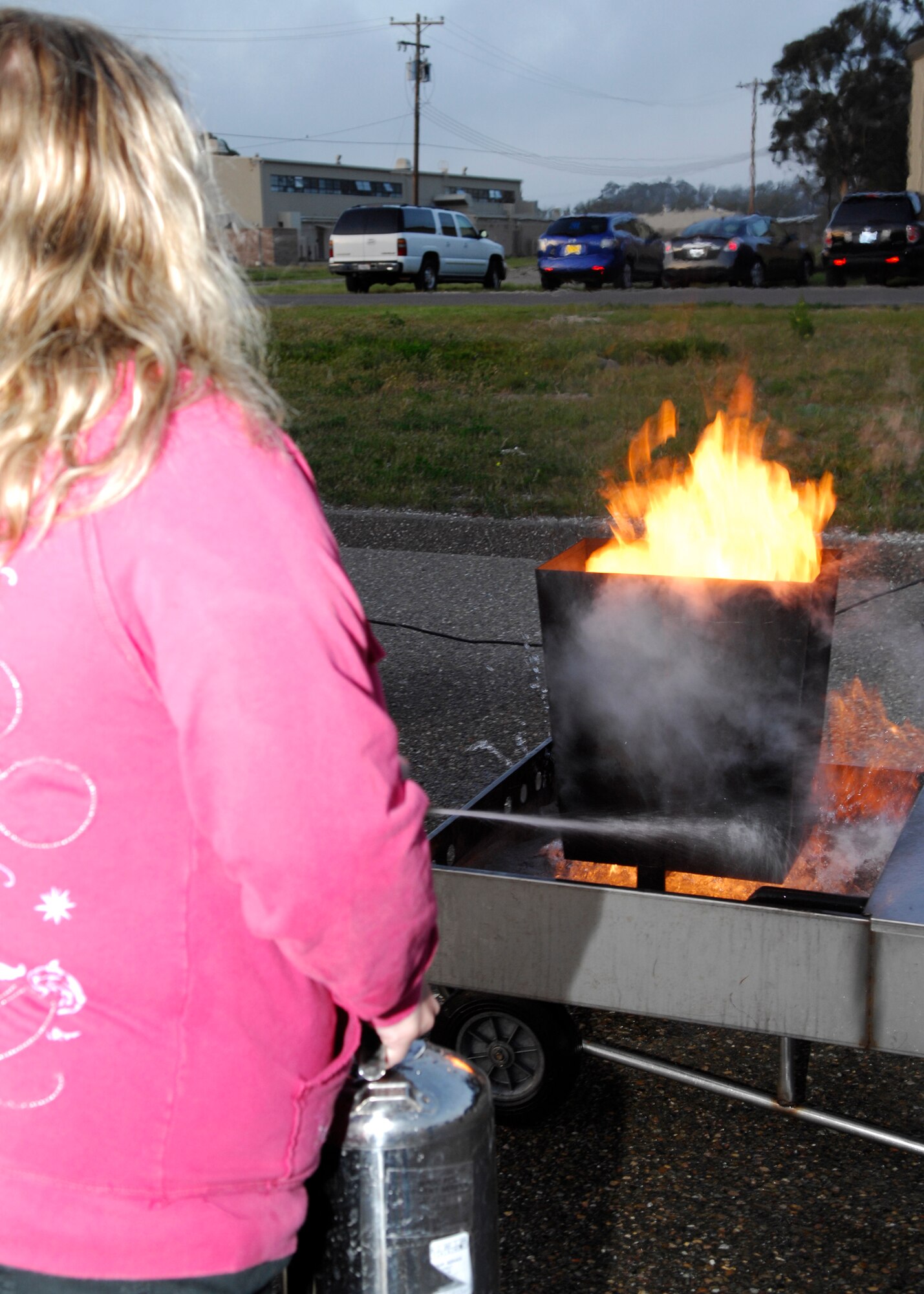 VANDENBERG AIR FORCE BASE, Calif. -- Using proper techniques, Christine Yarnes, spouse of Staff Sgt. Robert Yarnes of the 614th Air Operations Squadron here, attempts to extinguish a fire during training here Thursday, March 18, 2010. The training was provided to ensure base childcare providers know how to use fire extinguishers in case of an emergency. (U.S. Air Force photo/Senior Airman Heather R. Shaw)
