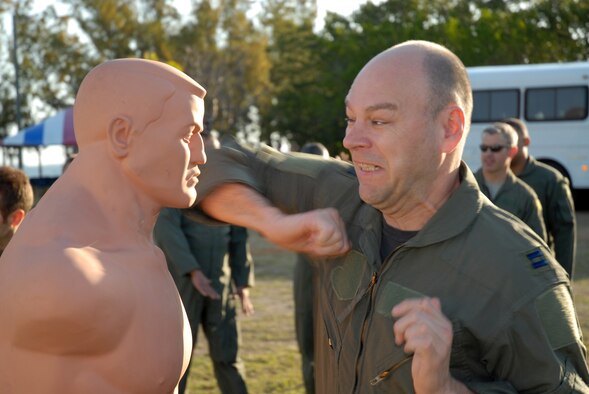 Capt Shane Buckland, C-40 Pilot with the 201st Airlift Squadron, practices an elbow strike as part of hand-to-hand combat training at Naval Air Station Key West, Fla. Mar. 15.  Capt. Buckland was promoted to Maj. in an informal ceremony following the water survival training. (U.S. Air Force photo by Tech. Sgt Tyrell Heaton/Released)