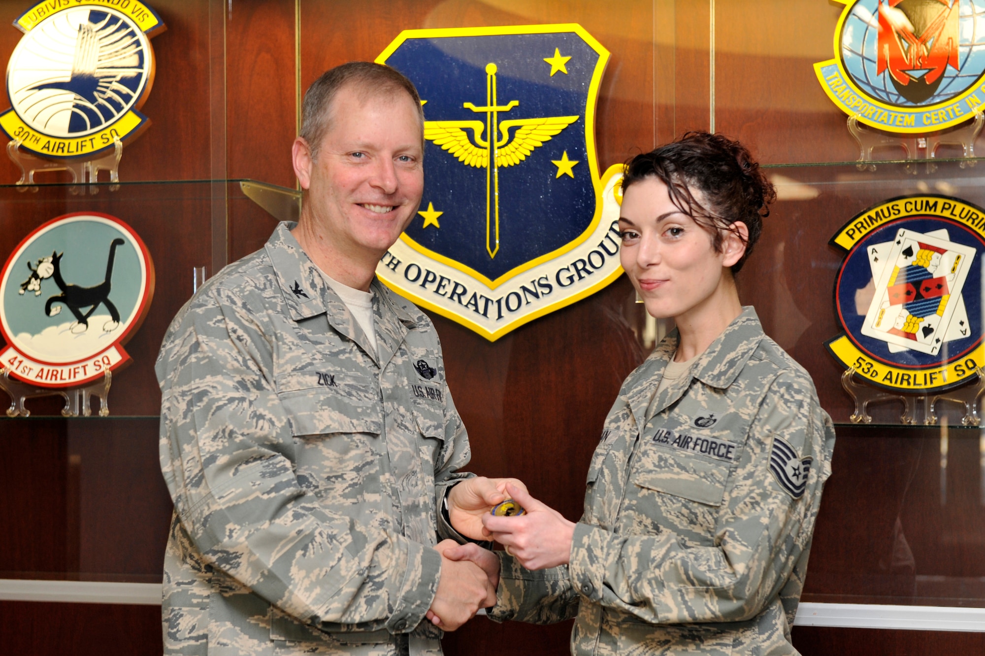 Col. Michael Zick, 19th Airlift Wing vice commander, presents a commander’s coin to Sergeant Pagan Tuesday at Bldg. 320 for her selection as the Combat Airlifter of the Week. Sergeant Pagan earned the Combat Airlifter of the Week for her exceptional performance in her duties which include responsibility for financial management oversight of eight squadrons and execution of the largest group budget on base, total over $4.7 million in operations and maintenance funds. (U.S. Air Force by Senior Airman Christine Clark) 