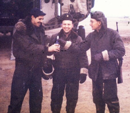 Lt. Col. Bruce Hinton (left) toasts with bravado just before boarding the last transport to leave Kimpo Air Base on Jan. 2, 1951, before it was overrun by Chinese forces. (U.S. Air Force photo)