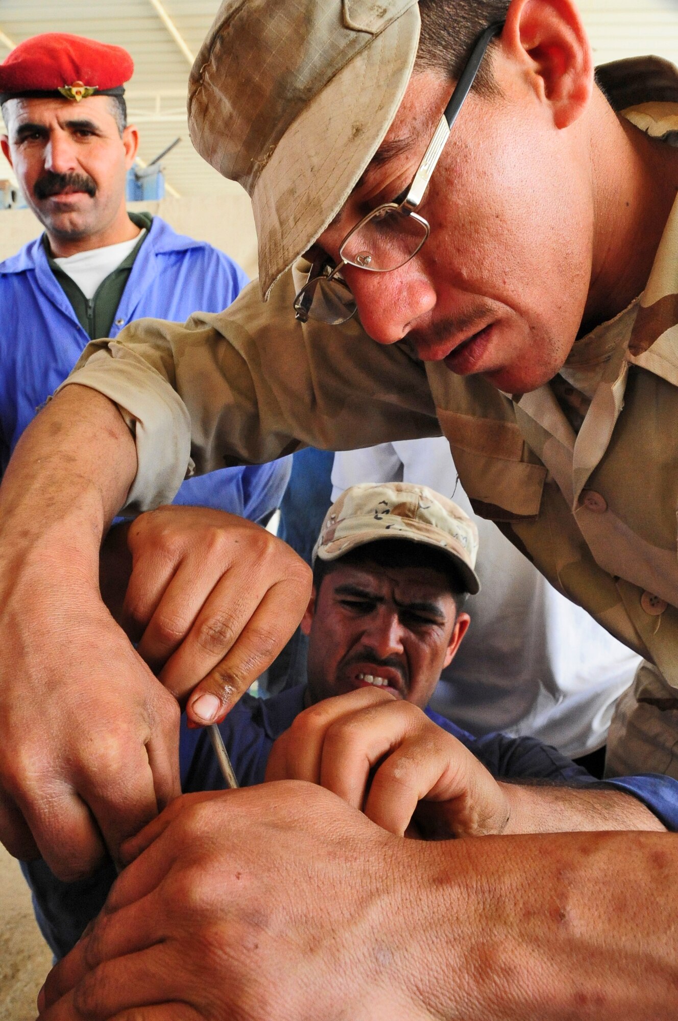 Iraqi Army Sgt. Nuqdad Ahmed, vehicle maintenance technician along with his counterparts disassemble components of an Allison transmission during a transmission training course hosted by the Logistics Military Advisory Team at Camp Ur, Iraq March 22, 2010.  (U.S. Air Force photo by Staff Sgt. Miguel Lara III/released)